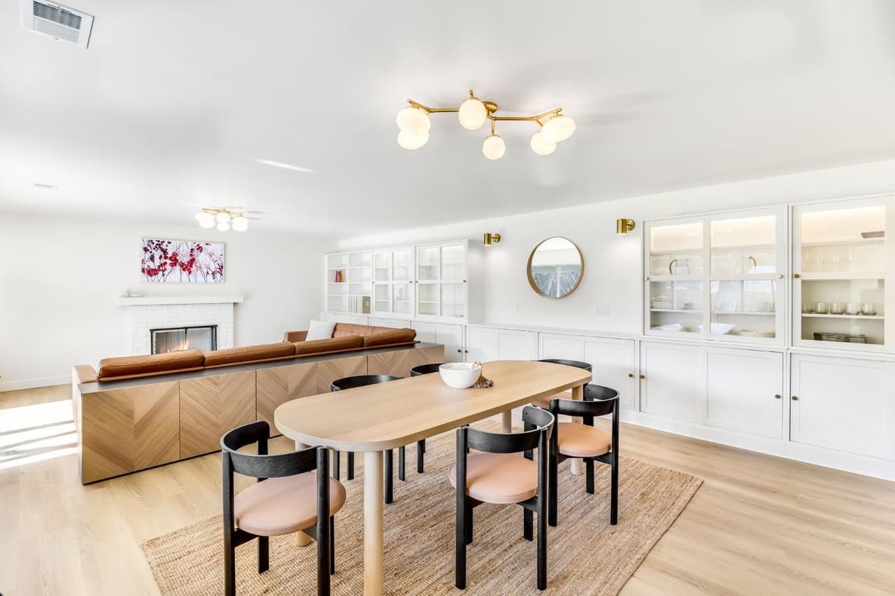 House Renovation in Davis — open-concept layout, built-in shelving, fireplace, hardwood flooring, framed mirror