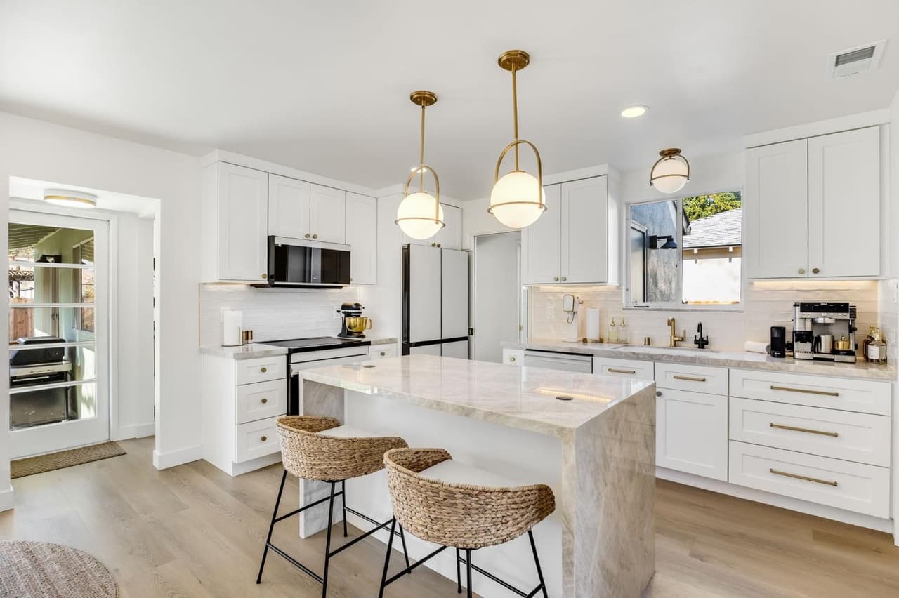 House Renovation in Davis — shaker cabinets, kitchen island, marble countertop, pendant lighting, subway tile backsplash