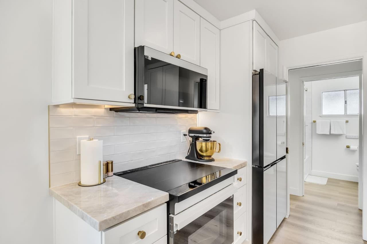 House Renovation in Davis — shaker cabinets, subway tile backsplash, quartz countertop, induction cooktop, under-cabinet lighting