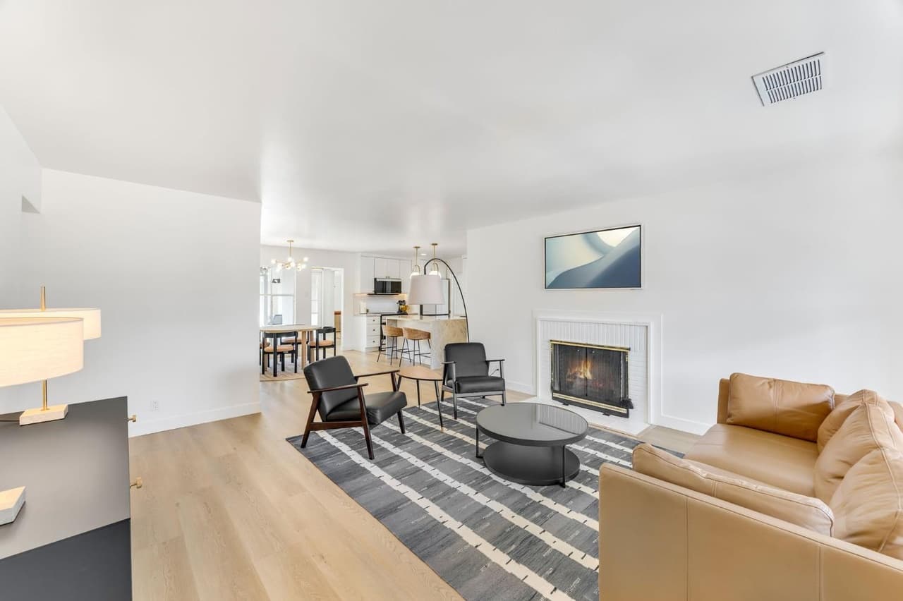 House Renovation in Davis — open-concept layout, fireplace, hardwood flooring, pendant lighting, breakfast bar