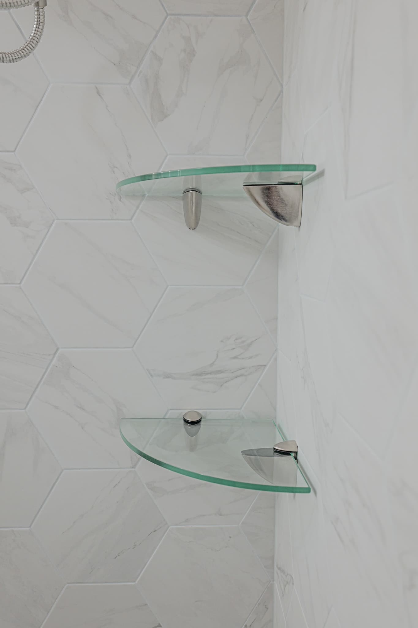 House Renovation in Sacramento — walk-in shower, tiled shower surround, handheld shower, built-in shelving, marble tile flooring