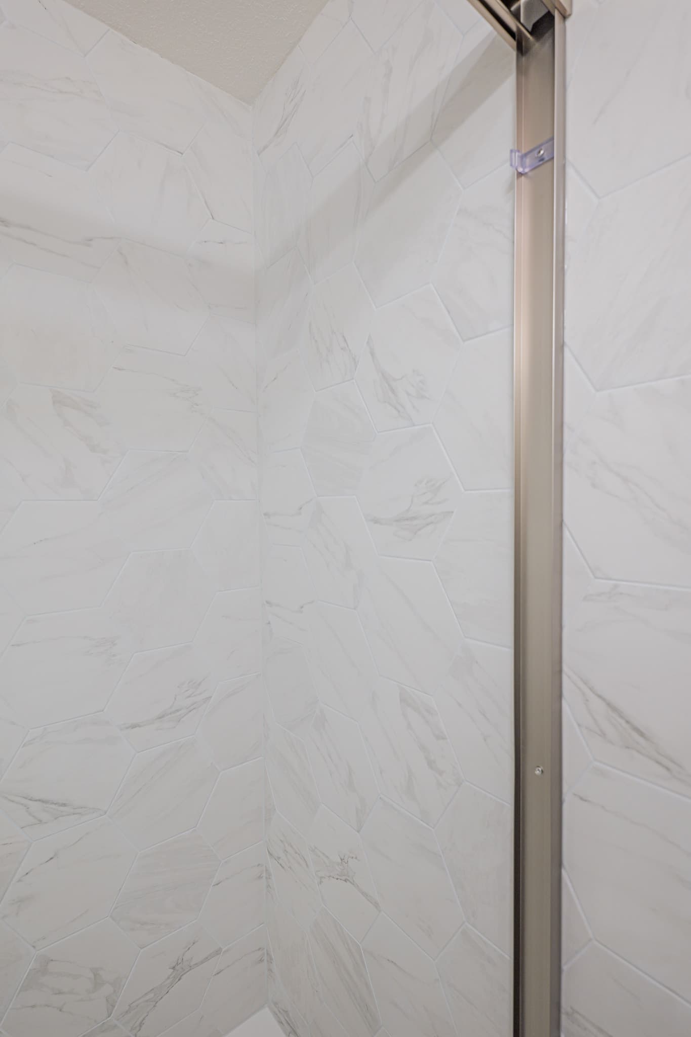 House Renovation in Sacramento — walk-in shower, frameless glass shower, tiled shower surround, marble tile flooring, mosaic backsplash