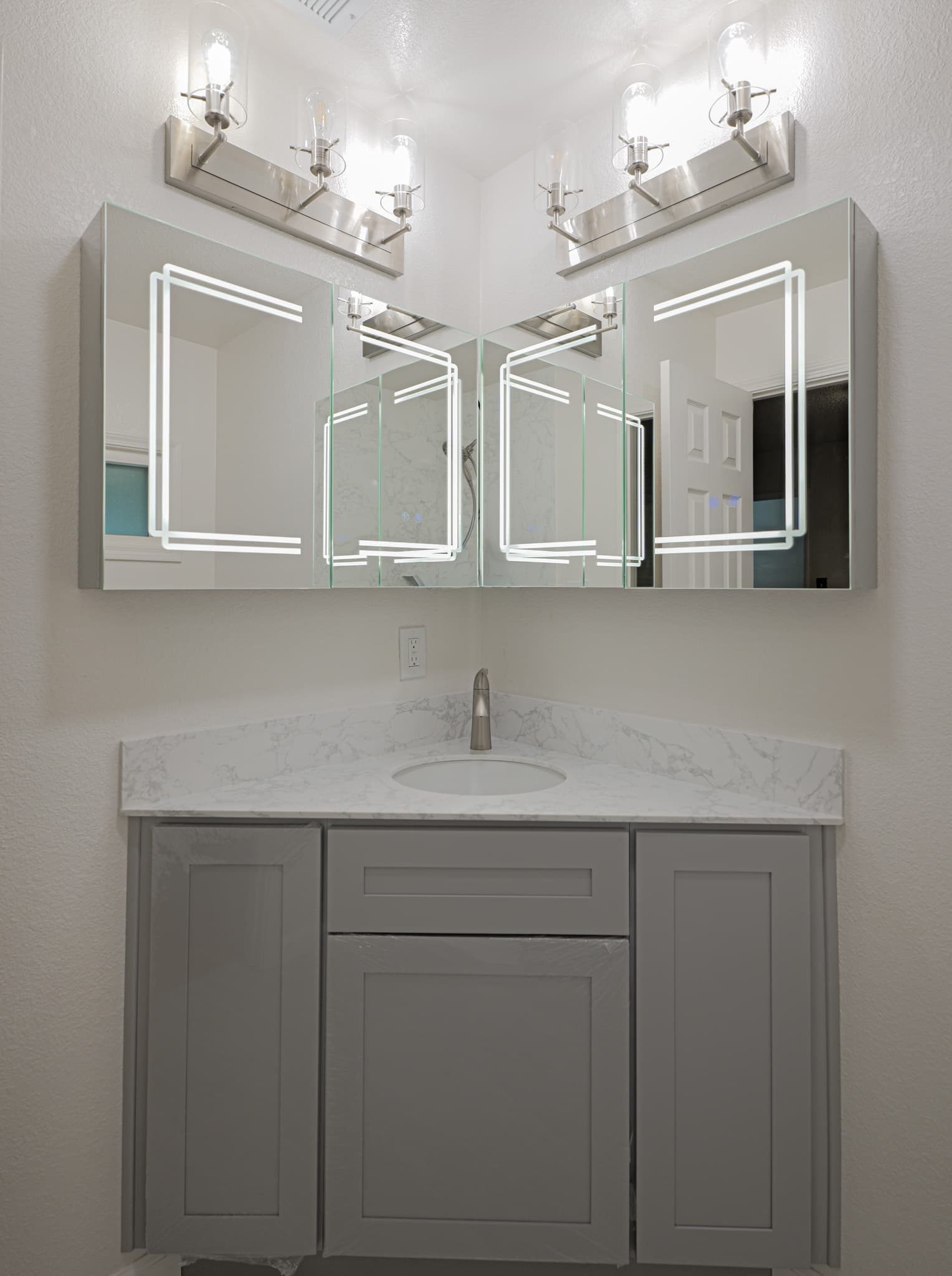 House Renovation in Sacramento — single vanity, shaker cabinets, lighted mirror, undermount sink, marble countertop