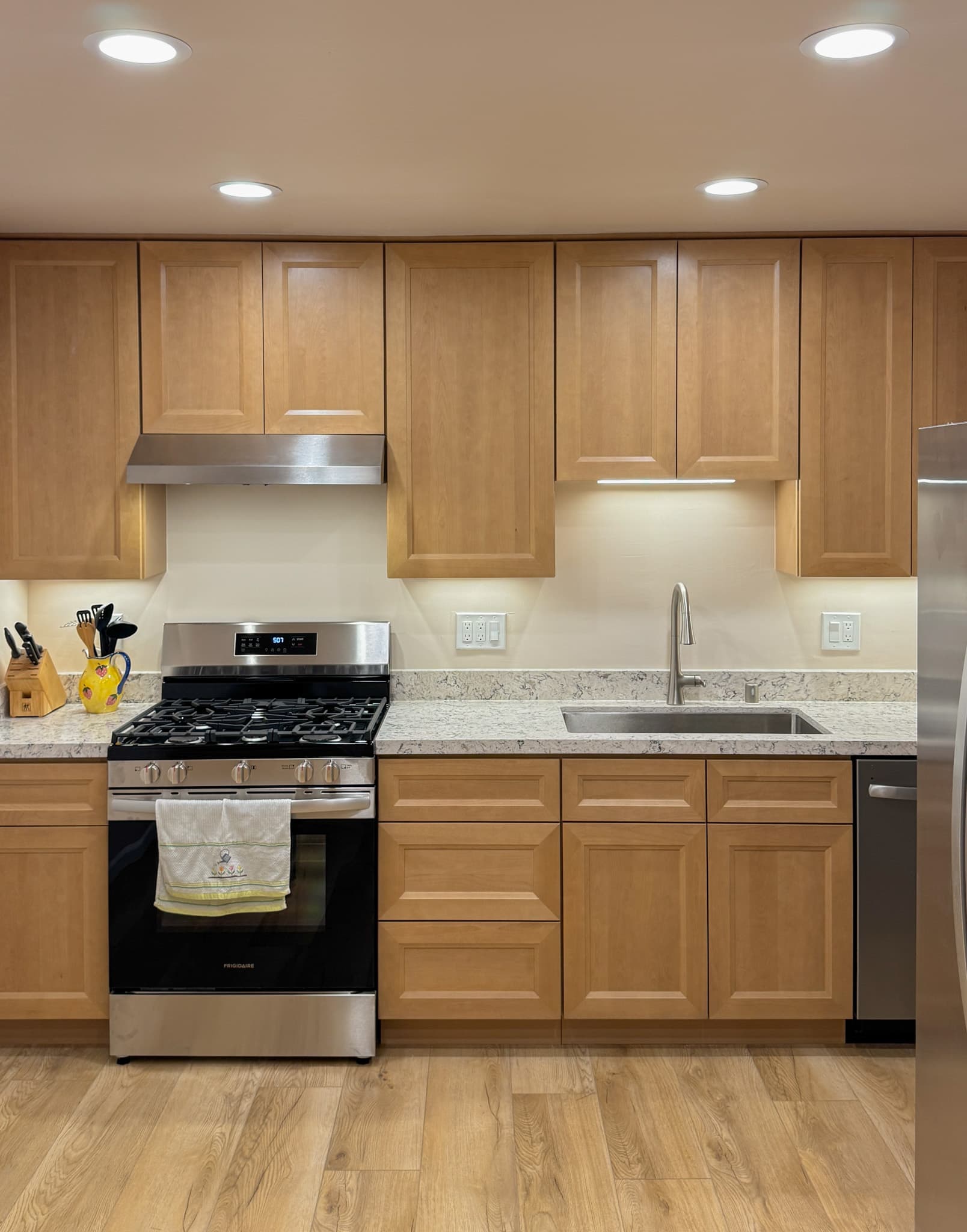 Kitchen Remodel in Sacramento — raised-panel cabinets, quartz countertop, undermount sink, recessed lighting, under-cabinet lighting