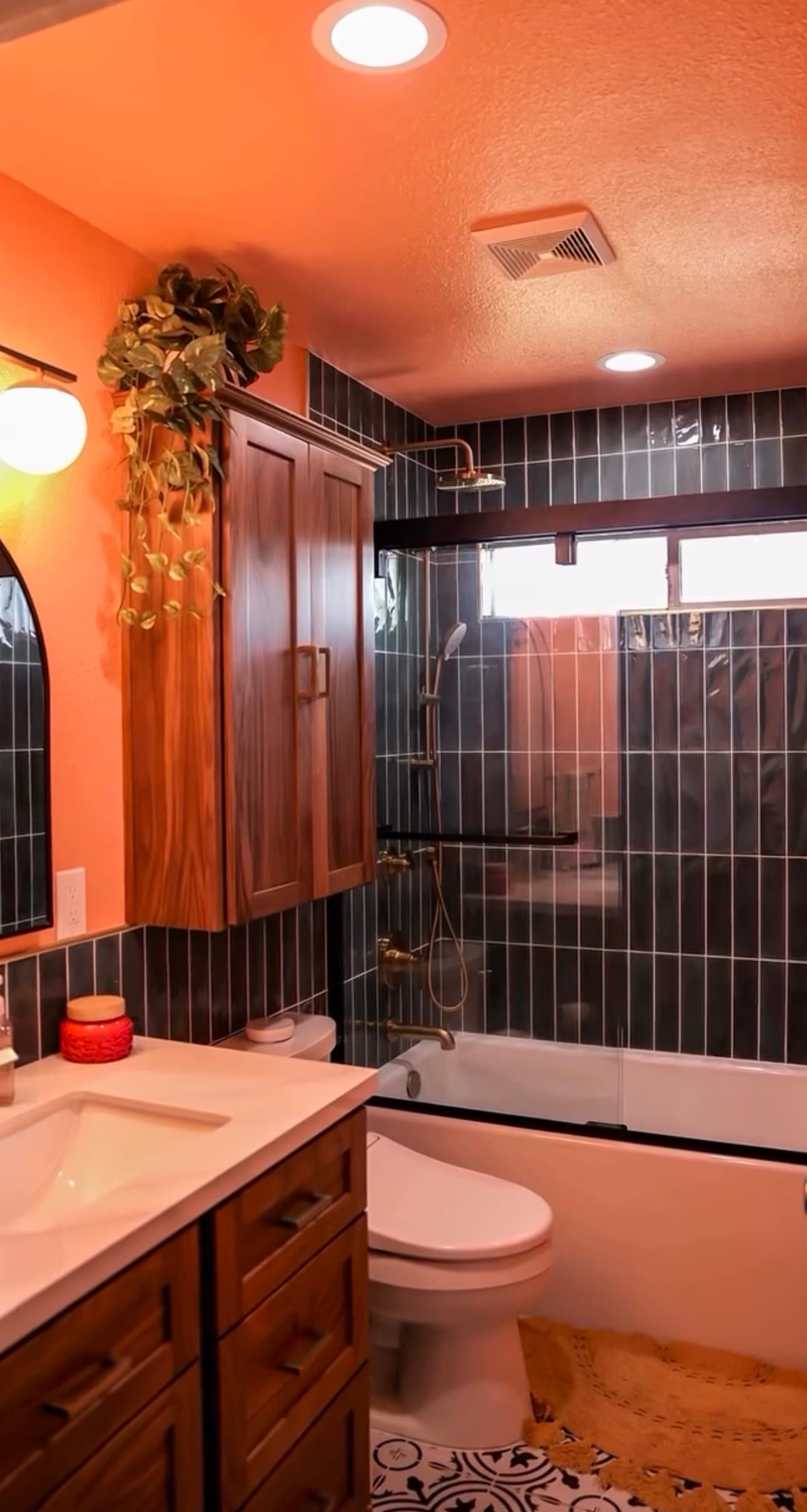 Bathroom Remodel in Citrus Heights — tiled shower surround, handheld shower, rain shower head, single vanity, recessed lighting