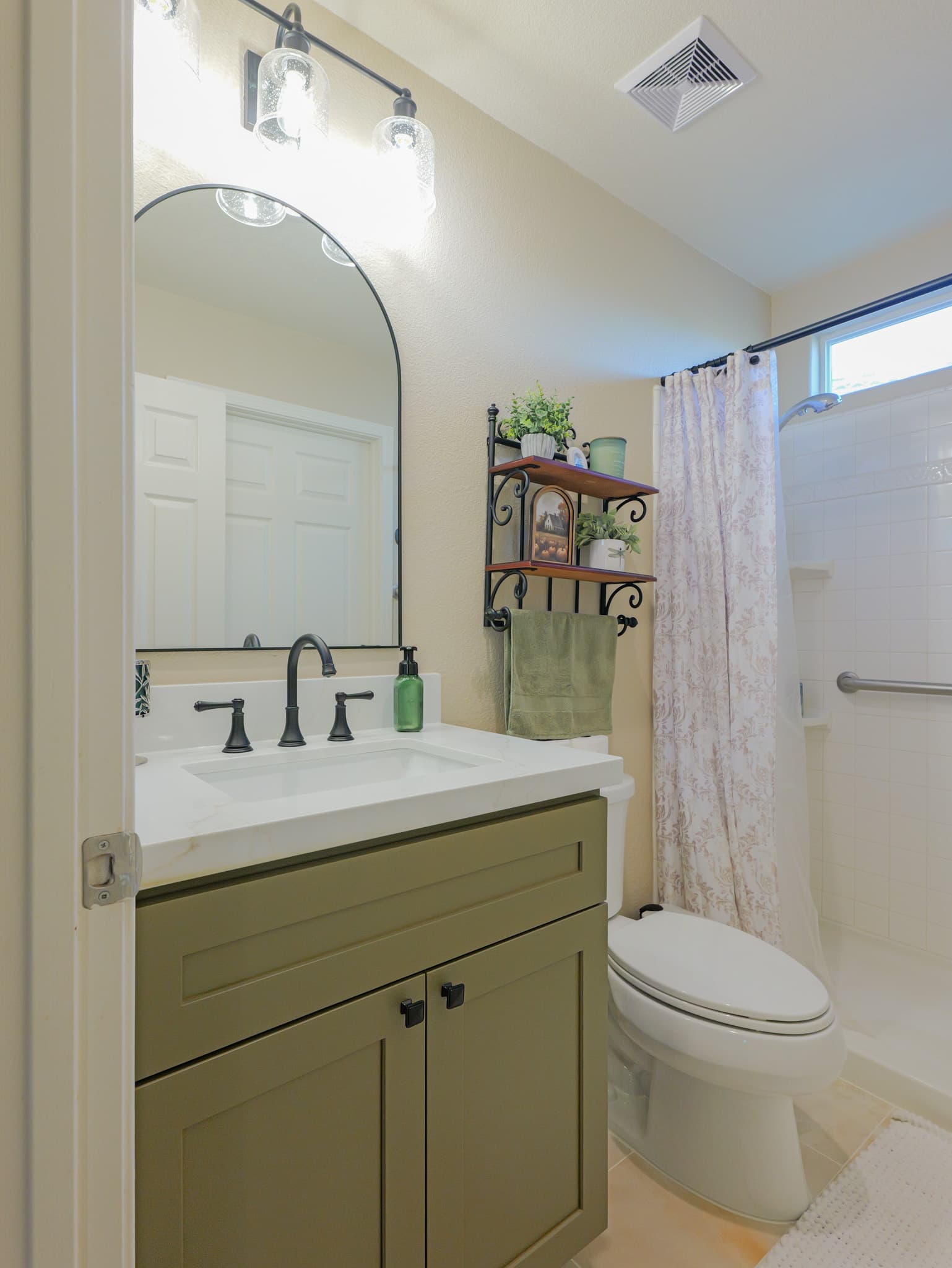 Bathroom Remodel in Sacramento — single vanity, shaker cabinets, framed mirror, undermount sink, tiled shower surround