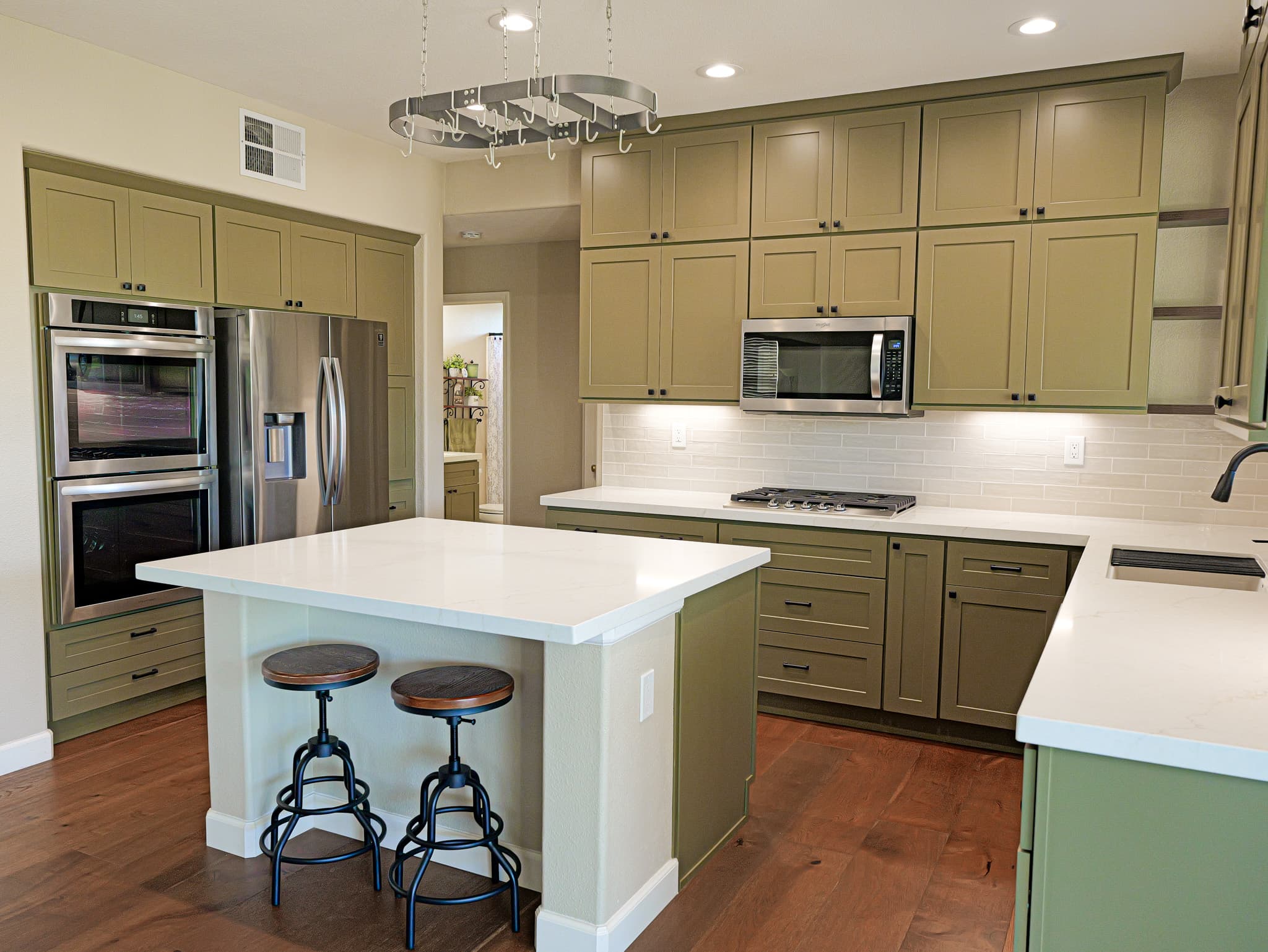 Bathroom Remodel in Sacramento — shaker cabinets, kitchen island, quartz countertop, subway tile backsplash, stainless appliances, hardwood flooring, recessed lighting, double oven
