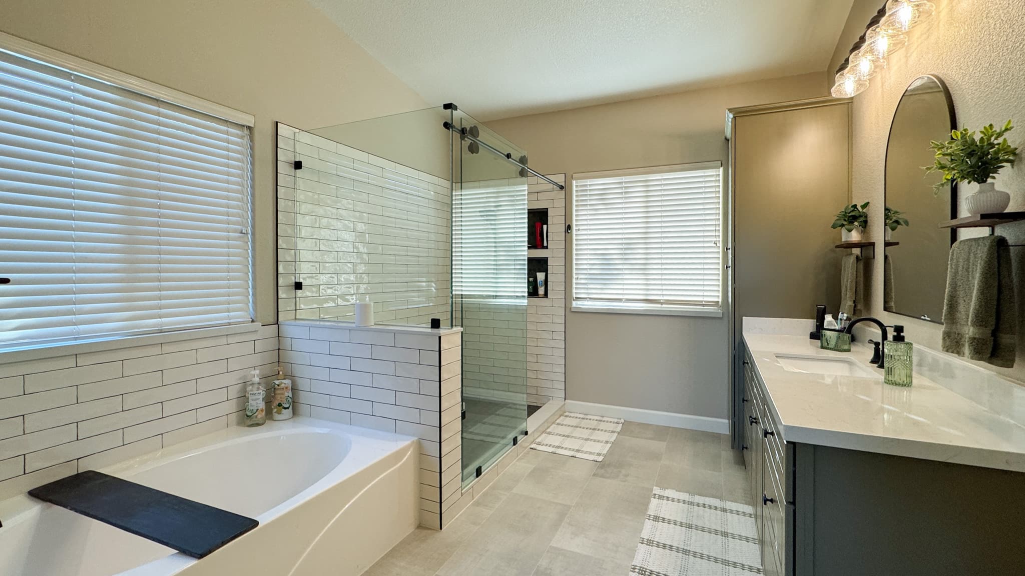 Bathroom Remodel in Sacramento — frameless glass shower, tiled shower surround, soaking tub, double vanity, subway tile backsplash