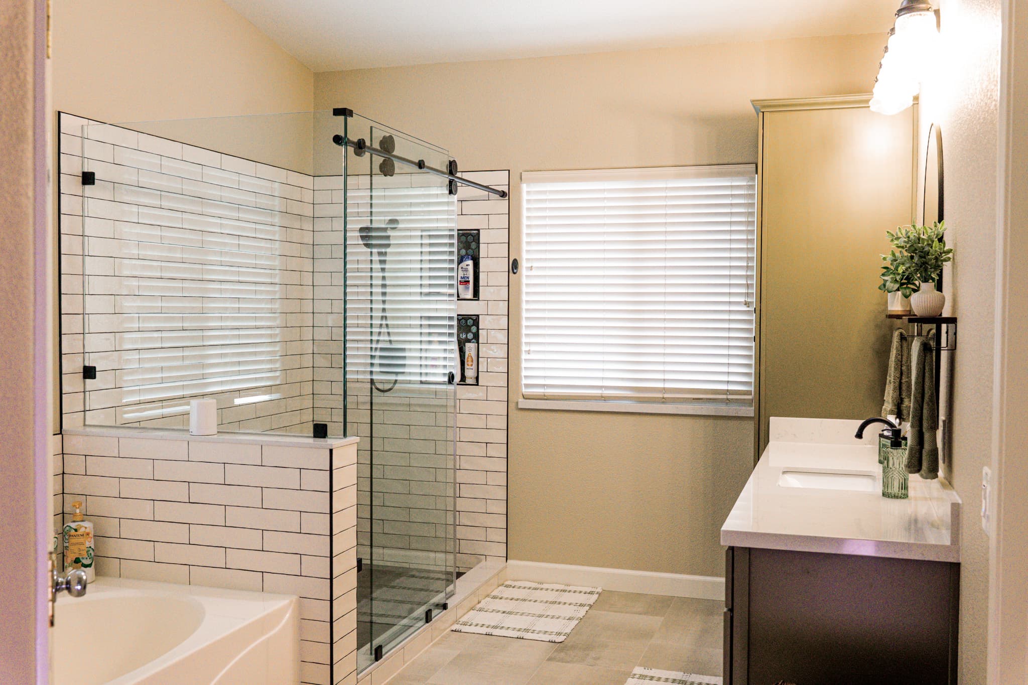 Bathroom Remodel in Sacramento — frameless glass shower, tiled shower surround, subway tile backsplash, single vanity, shower bench