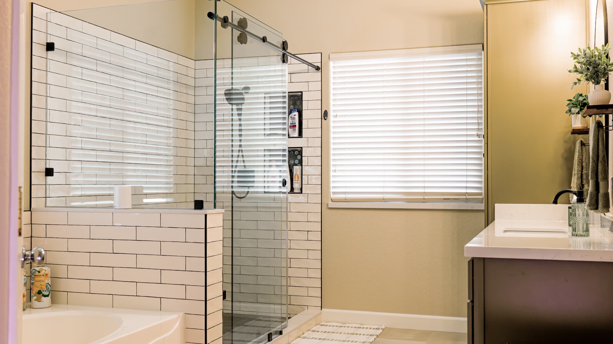 Bathroom Remodel in Sacramento — frameless glass shower, tiled shower surround, subway tile backsplash, handheld shower, single vanity