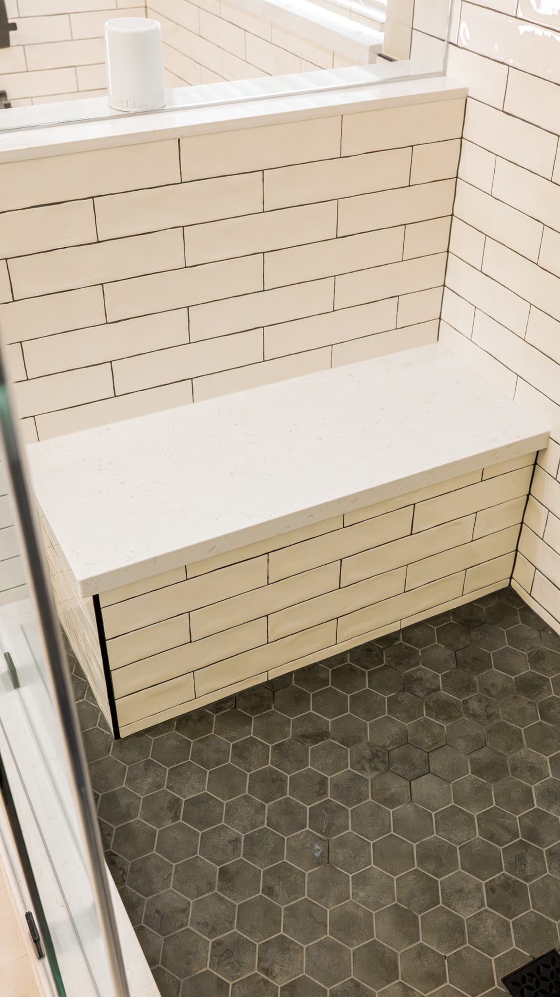 Bathroom Remodel in Sacramento — walk-in shower, shower bench, tiled shower surround, frameless glass shower, ceramic tile flooring