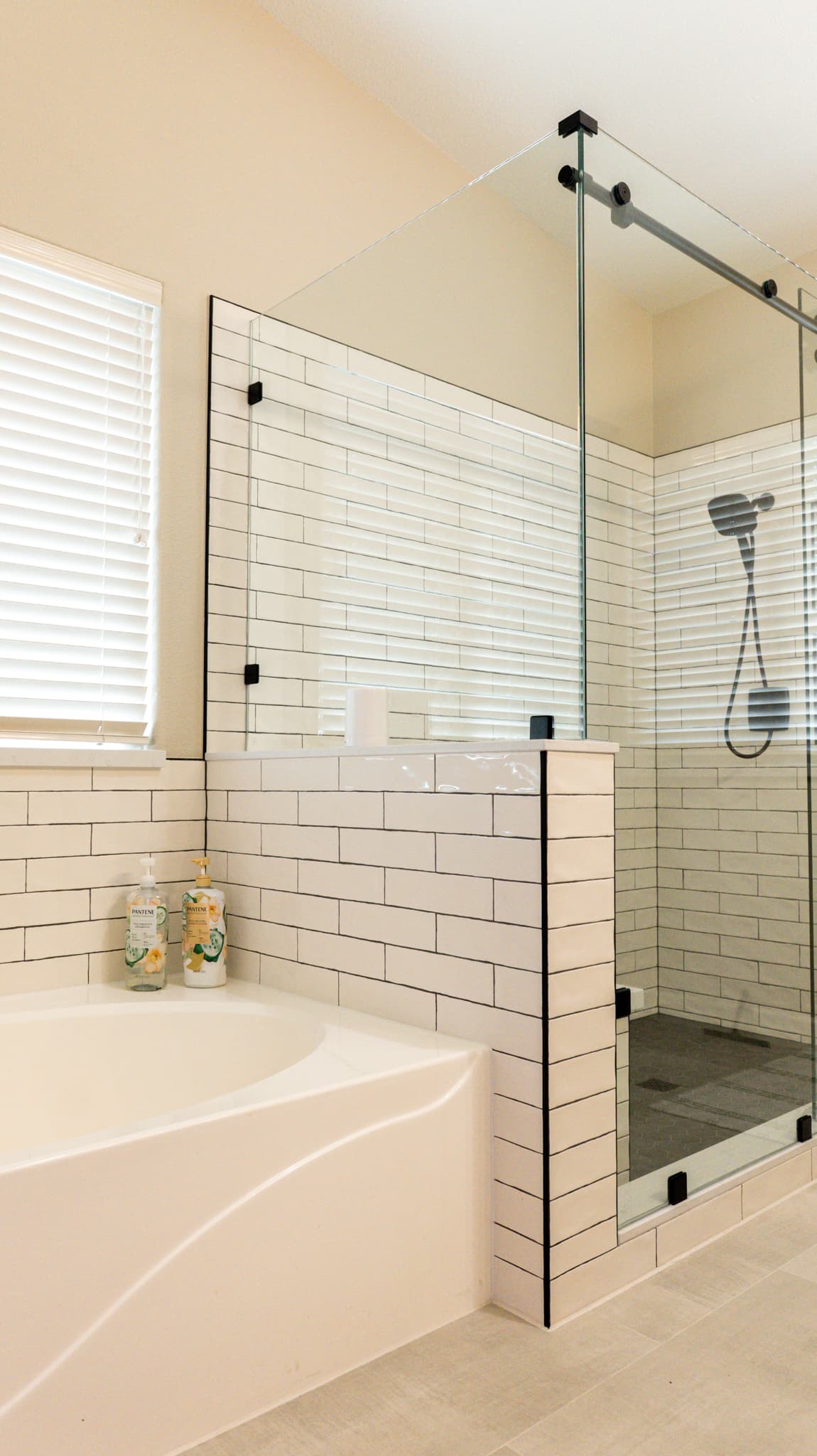 Bathroom Remodel in Sacramento — frameless glass shower, tiled shower surround, subway tile backsplash, soaking tub, handheld shower