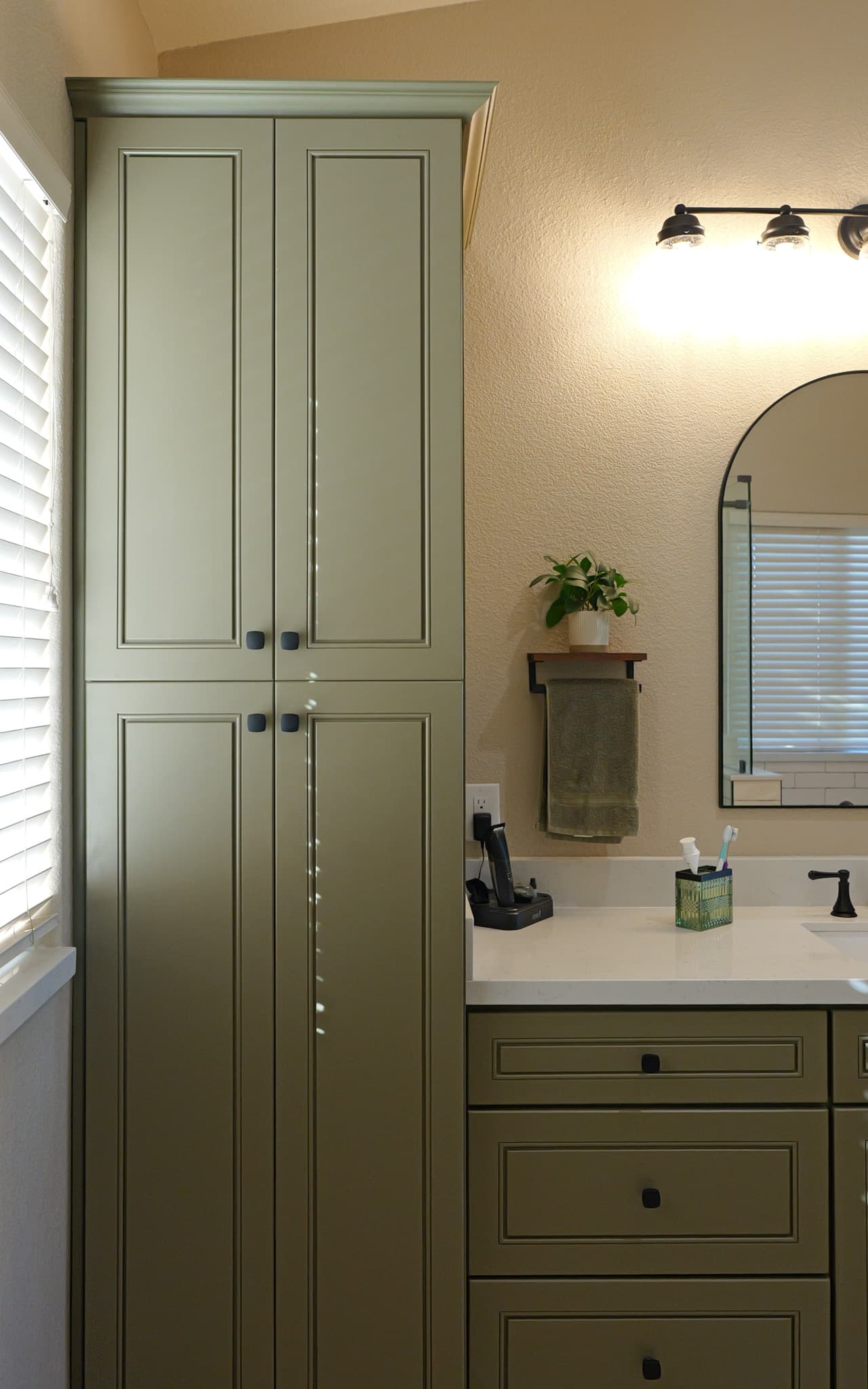 Bathroom Remodel in Sacramento — raised-panel cabinets, linen tower, single vanity, framed mirror, quartz countertop