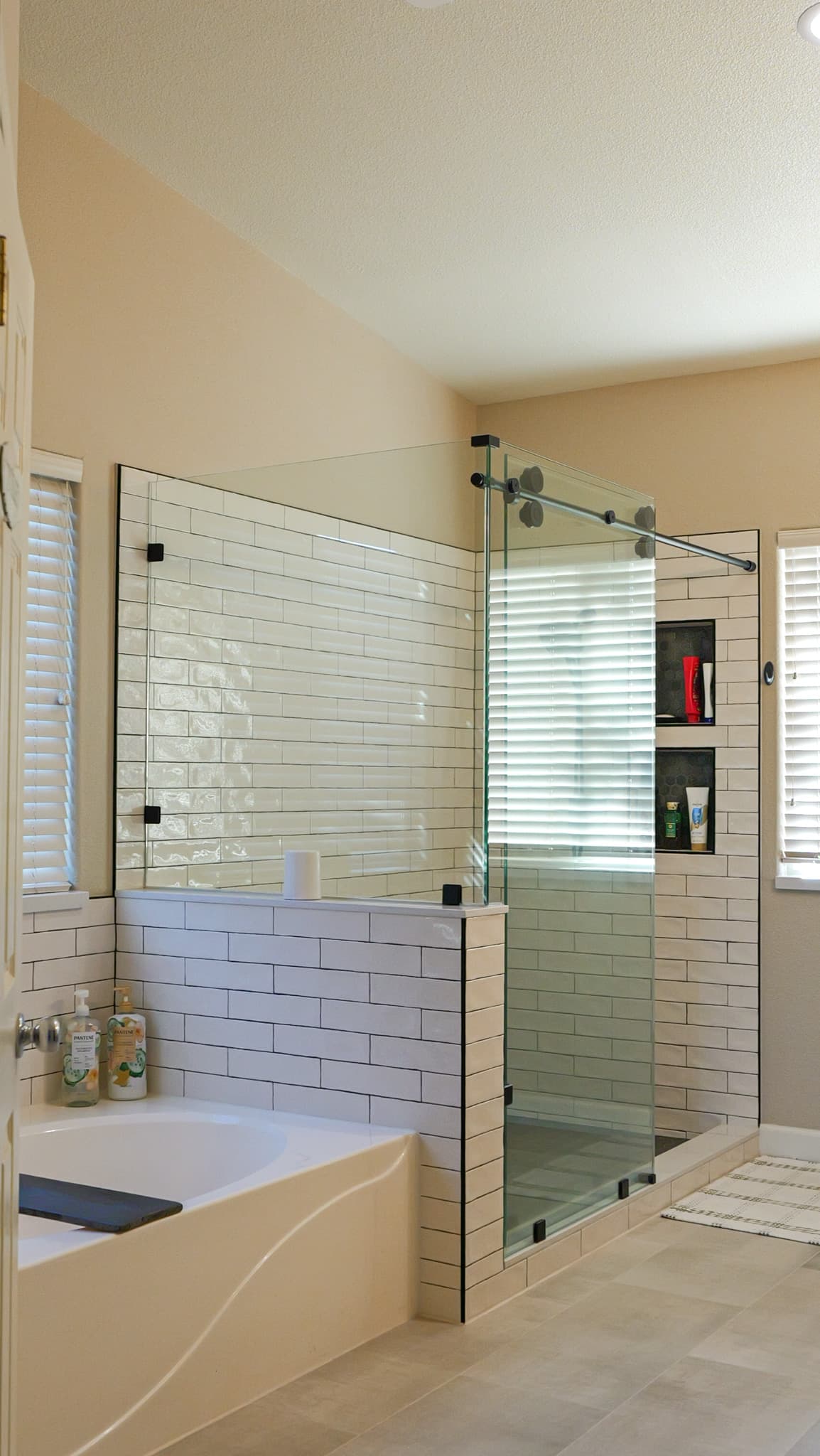 Bathroom Remodel in Sacramento — frameless glass shower, tiled shower surround, subway tile backsplash, soaking tub, built-in shelving
