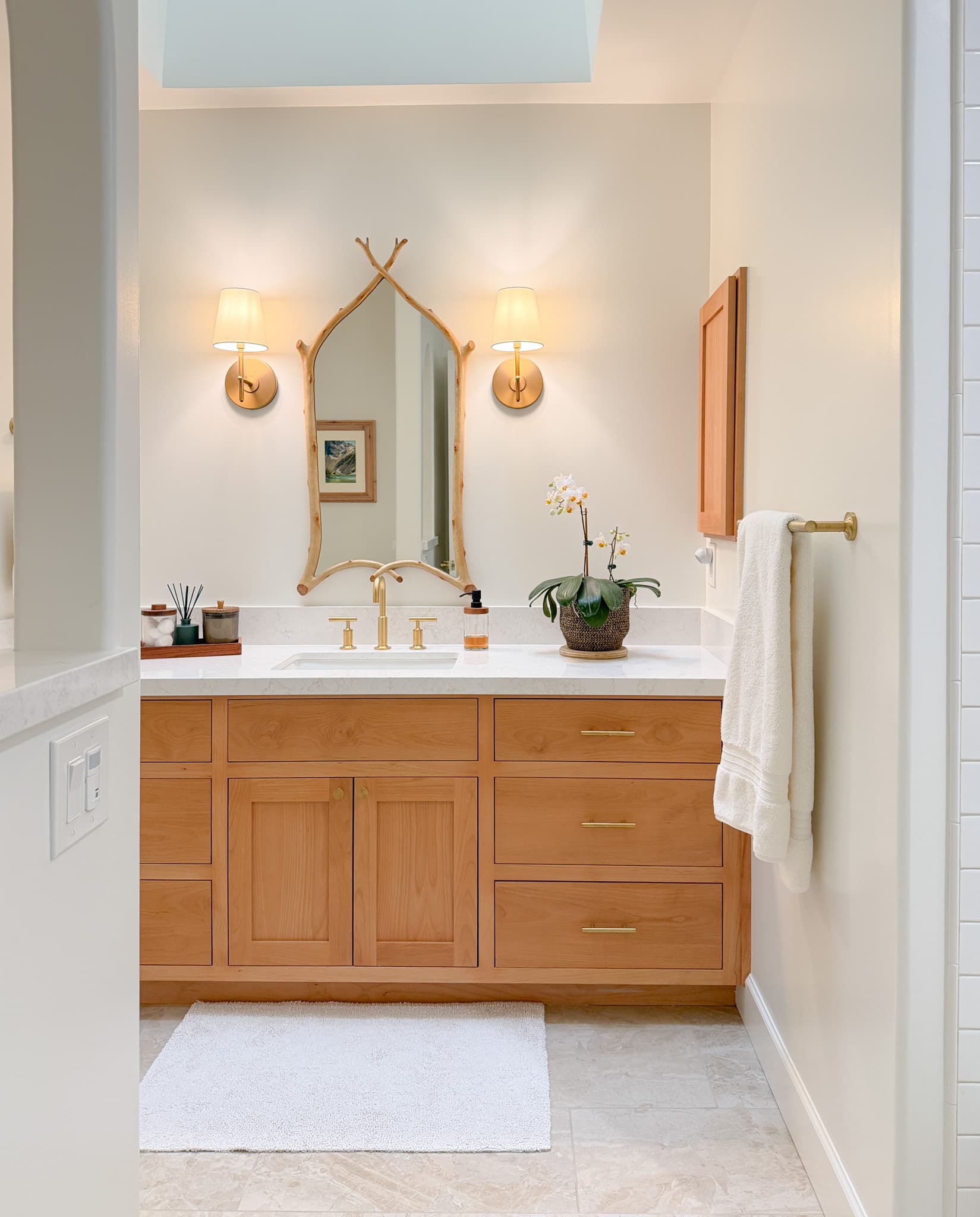 Bathroom Remodel in Carmichael — shaker cabinets, single vanity, undermount sink, quartz countertop, natural-stone tile flooring