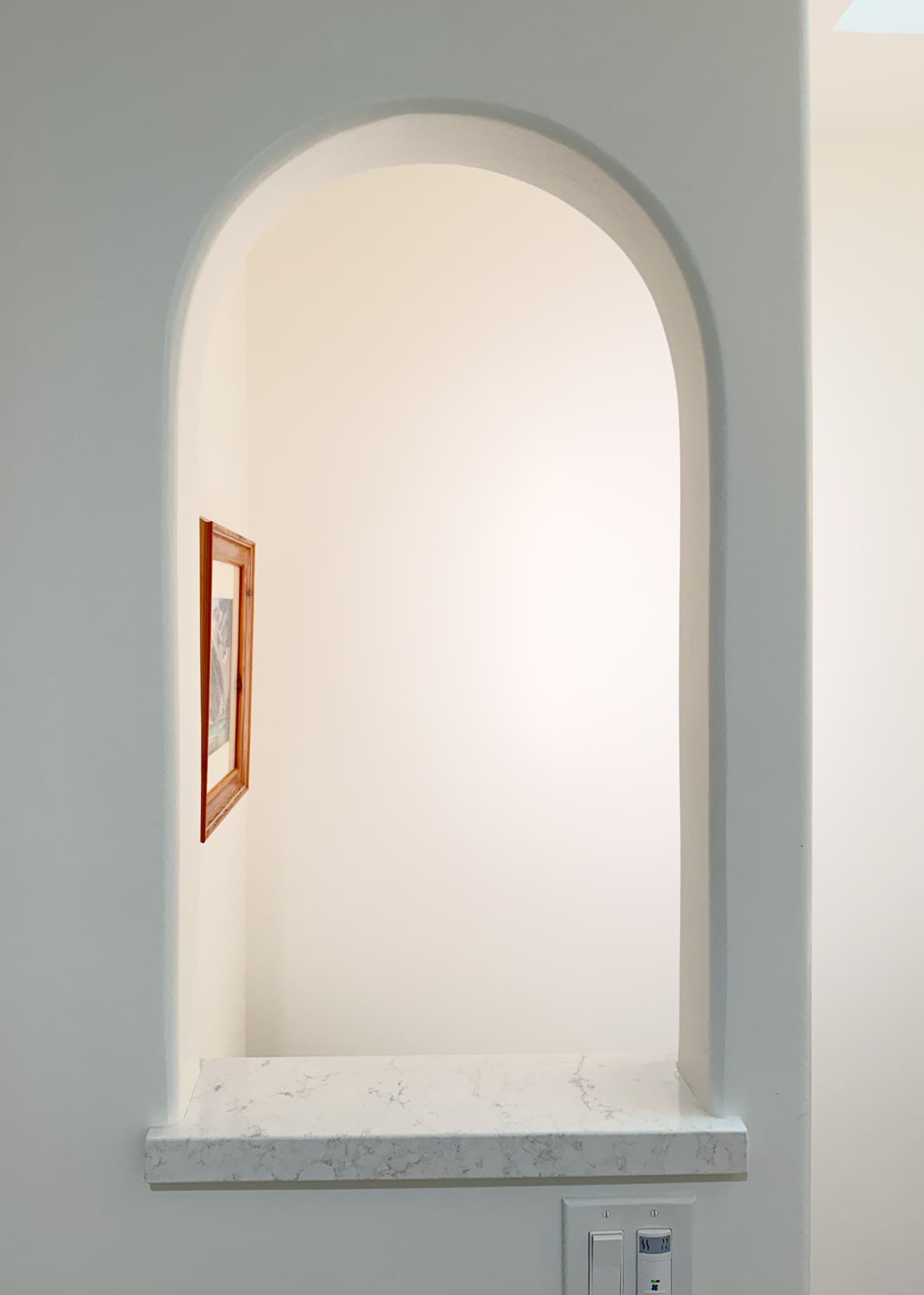Bathroom Remodel in Carmichael — quartz countertop, built-in shelving, recessed lighting, wainscoting