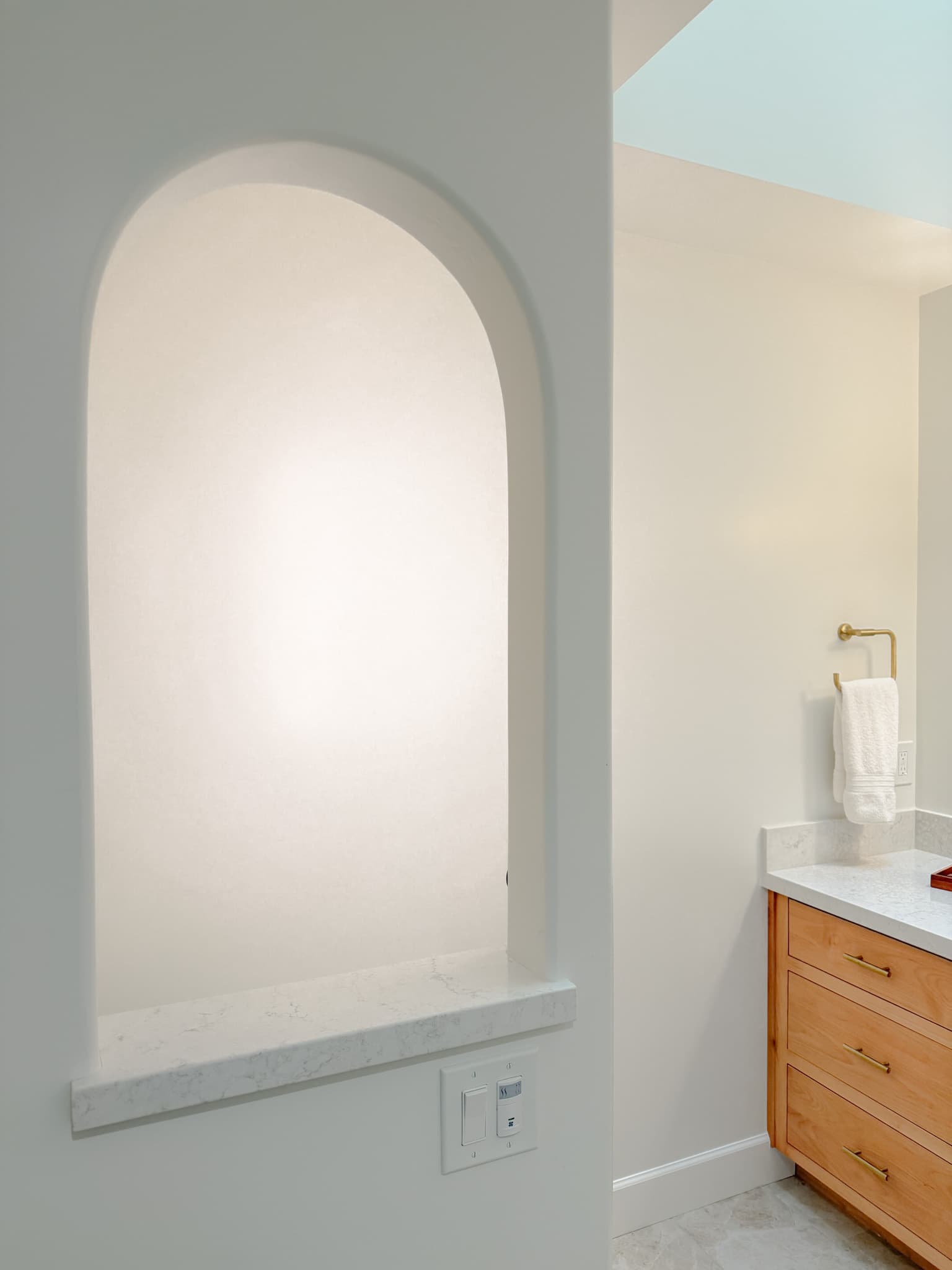 Bathroom Remodel in Carmichael — single vanity, quartz countertop, custom cabinetry, built-in shelving, marble tile flooring