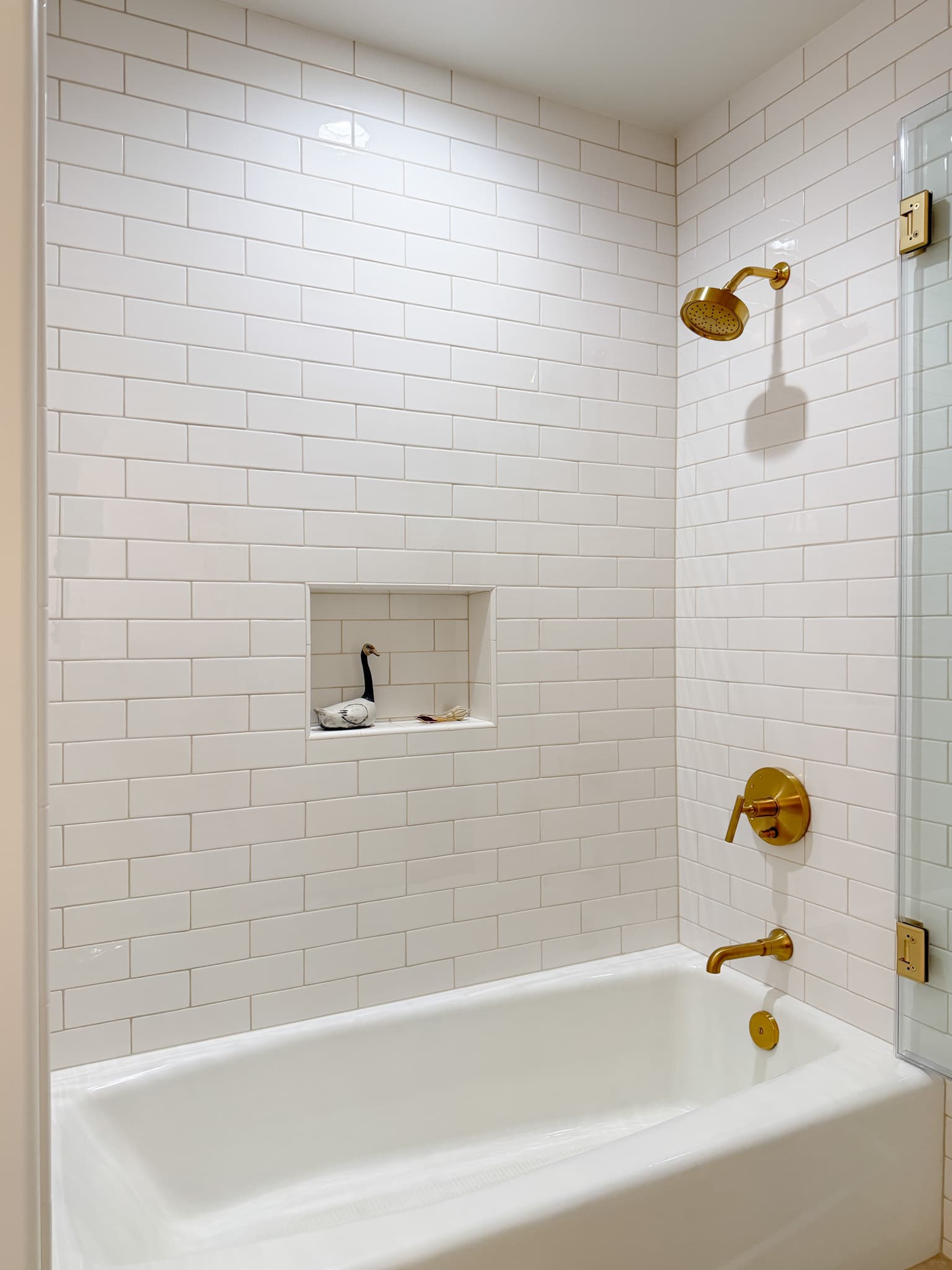 Bathroom Remodel in Carmichael — subway tile backsplash, tiled shower surround, soaking tub, rain shower head, frameless glass shower
