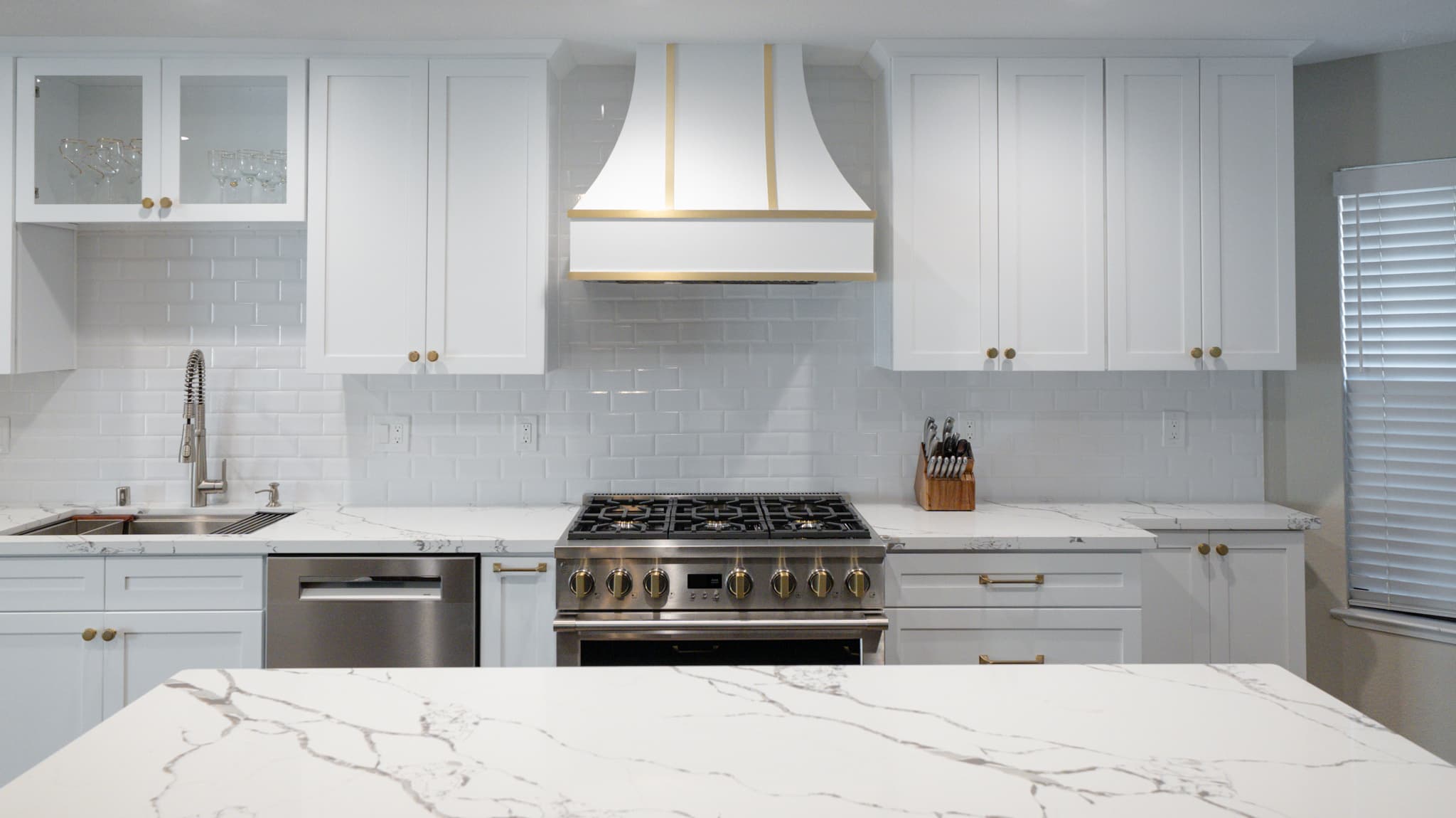Kitchen Remodel in Roseville — shaker cabinets, quartz countertop, subway tile backsplash, range hood, professional gas range