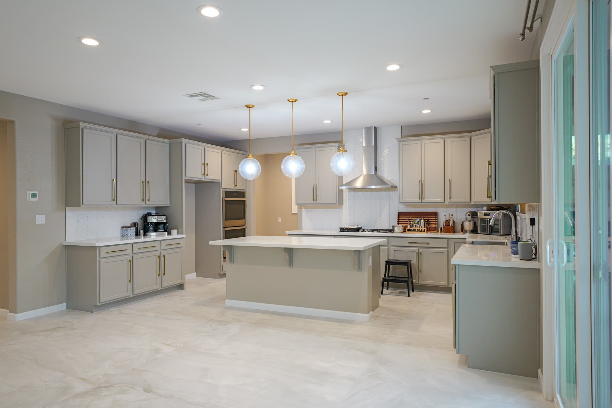 Kitchen Remodel in Sacramento — raised-panel cabinets, kitchen island, pendant lighting, recessed lighting, range hood