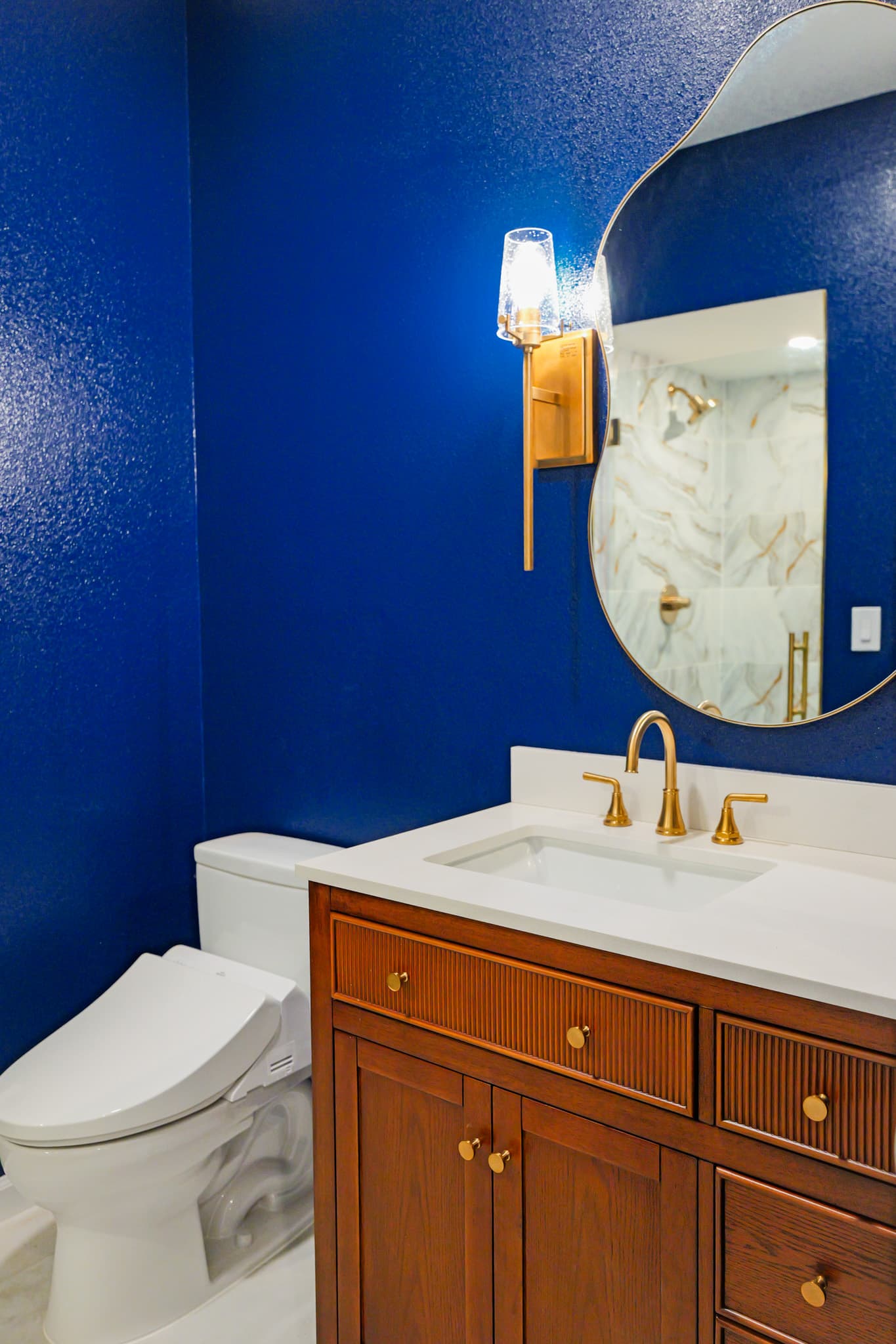 Kitchen Remodel in Sacramento — single vanity, undermount sink, quartz countertop, framed mirror, tiled shower surround