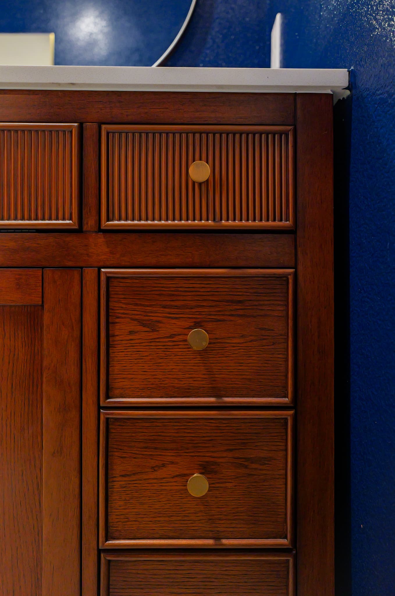 Kitchen Remodel in Sacramento — before remodel — original finishes, single vanity, raised-panel cabinets, framed mirror, linen tower