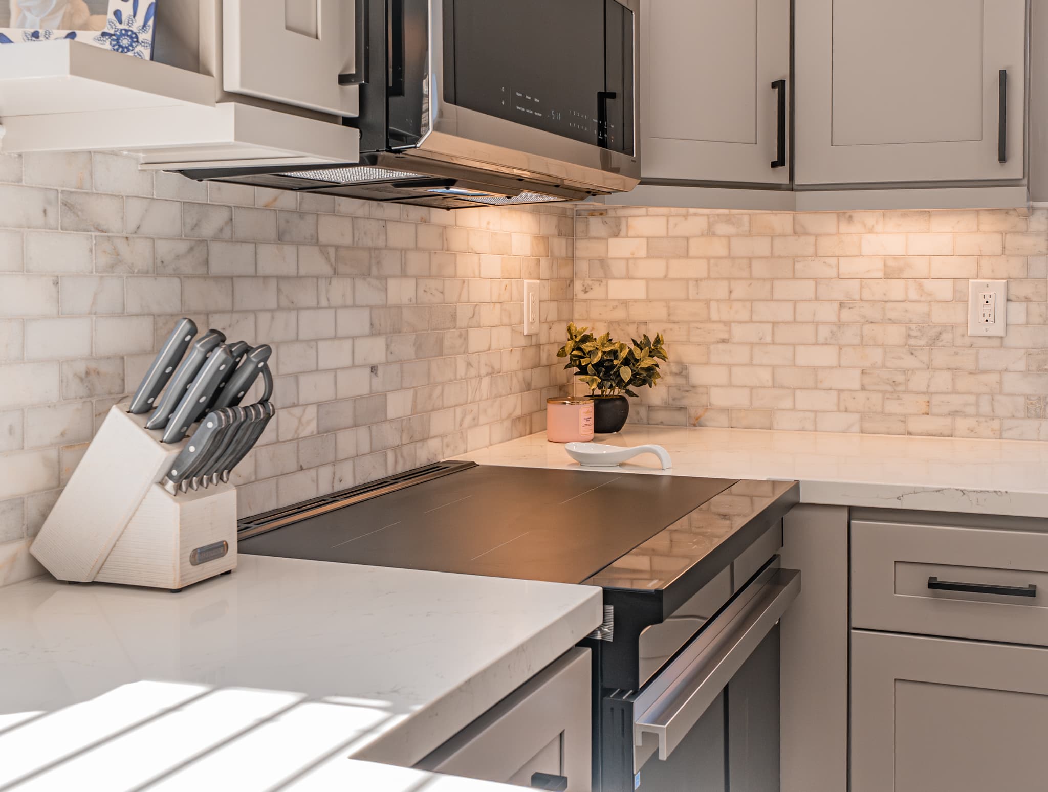 Kitchen Remodel in Citrus Heights — shaker cabinets, natural-stone backsplash, quartz countertop, under-cabinet lighting, induction cooktop