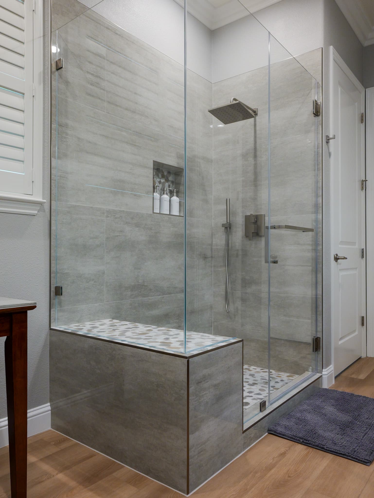 Bathroom Remodel in Roseville — frameless glass shower, walk-in shower, shower bench, rain shower head, handheld shower