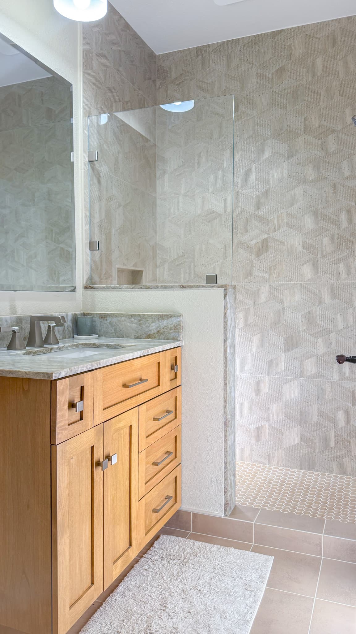 Bathroom Remodel in Sacramento — frameless glass shower, tiled shower surround, single vanity, undermount sink, porcelain tile flooring