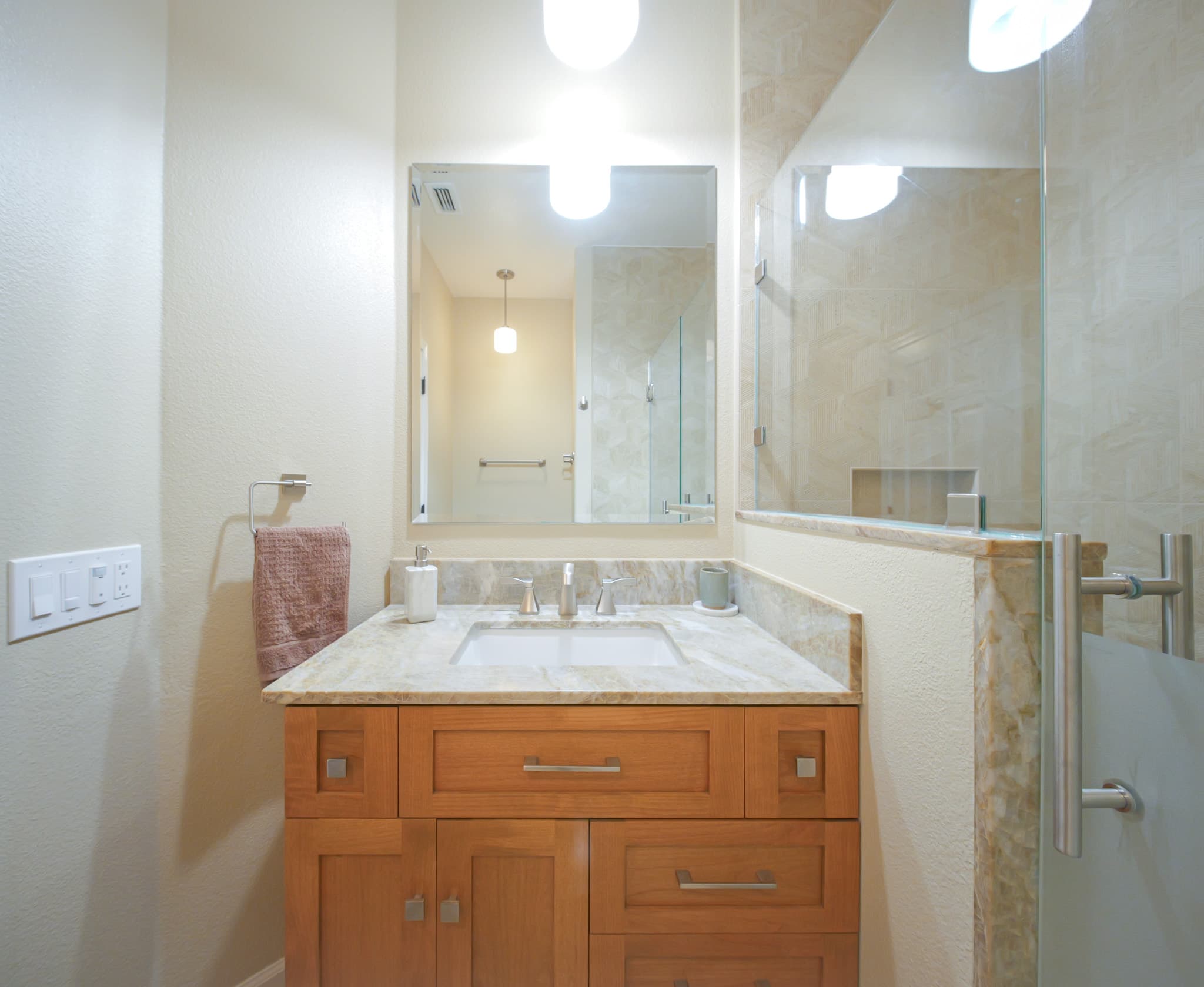 Bathroom Remodel in Sacramento — single vanity, undermount sink, marble countertop, frameless glass shower, tiled shower surround
