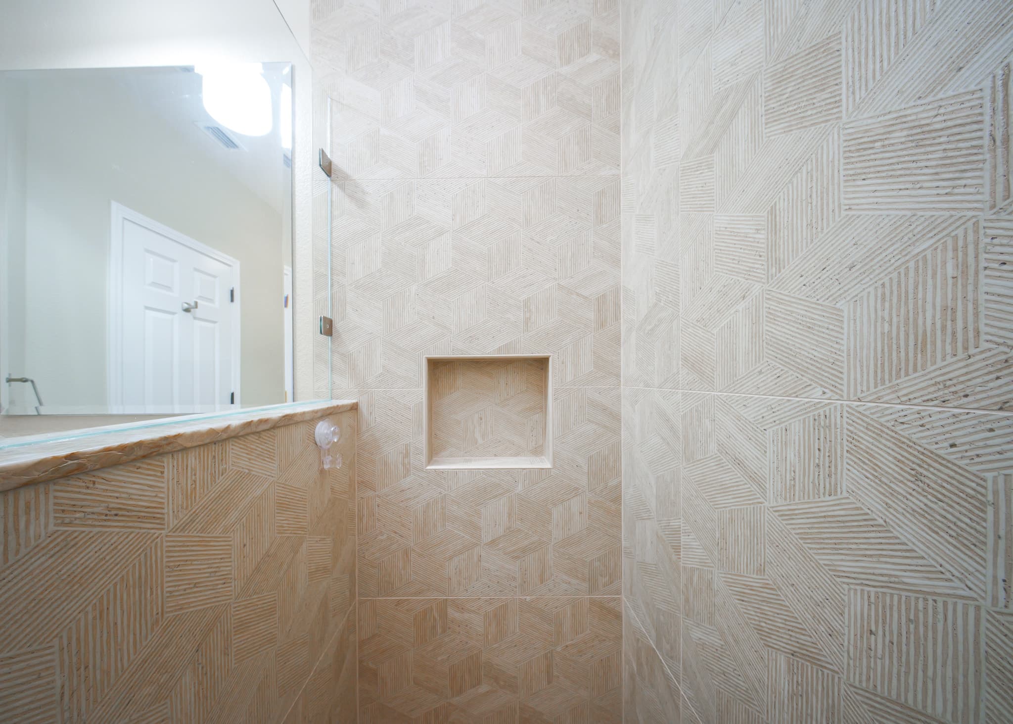 Bathroom Remodel in Sacramento — walk-in shower, frameless glass shower, tiled shower surround, natural-stone backsplash, framed mirror