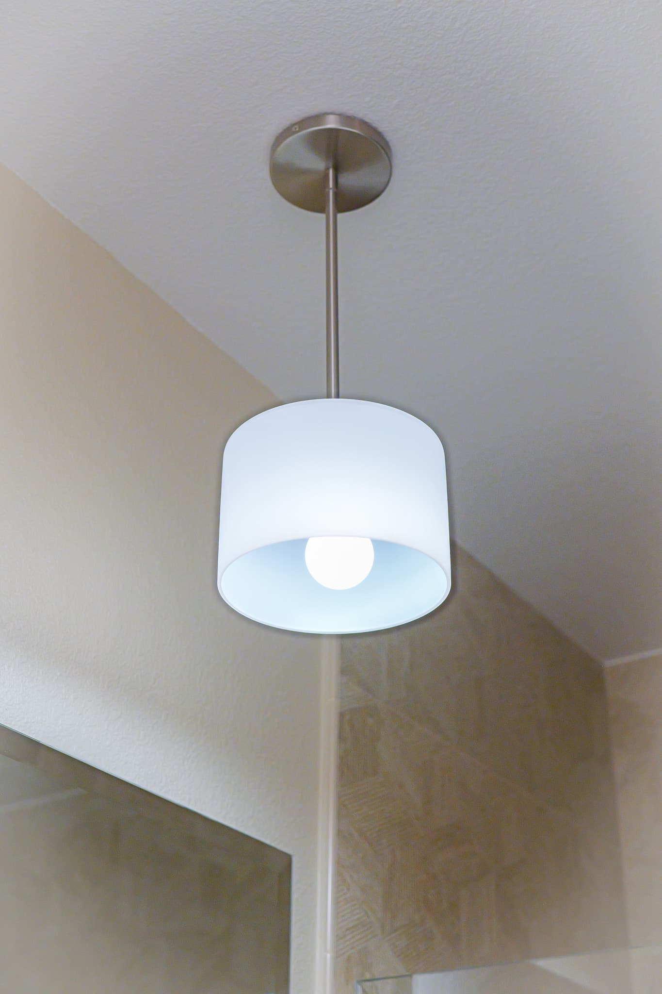 Bathroom Remodel in Sacramento — pendant lighting, framed mirror, tiled shower surround, frameless glass shower