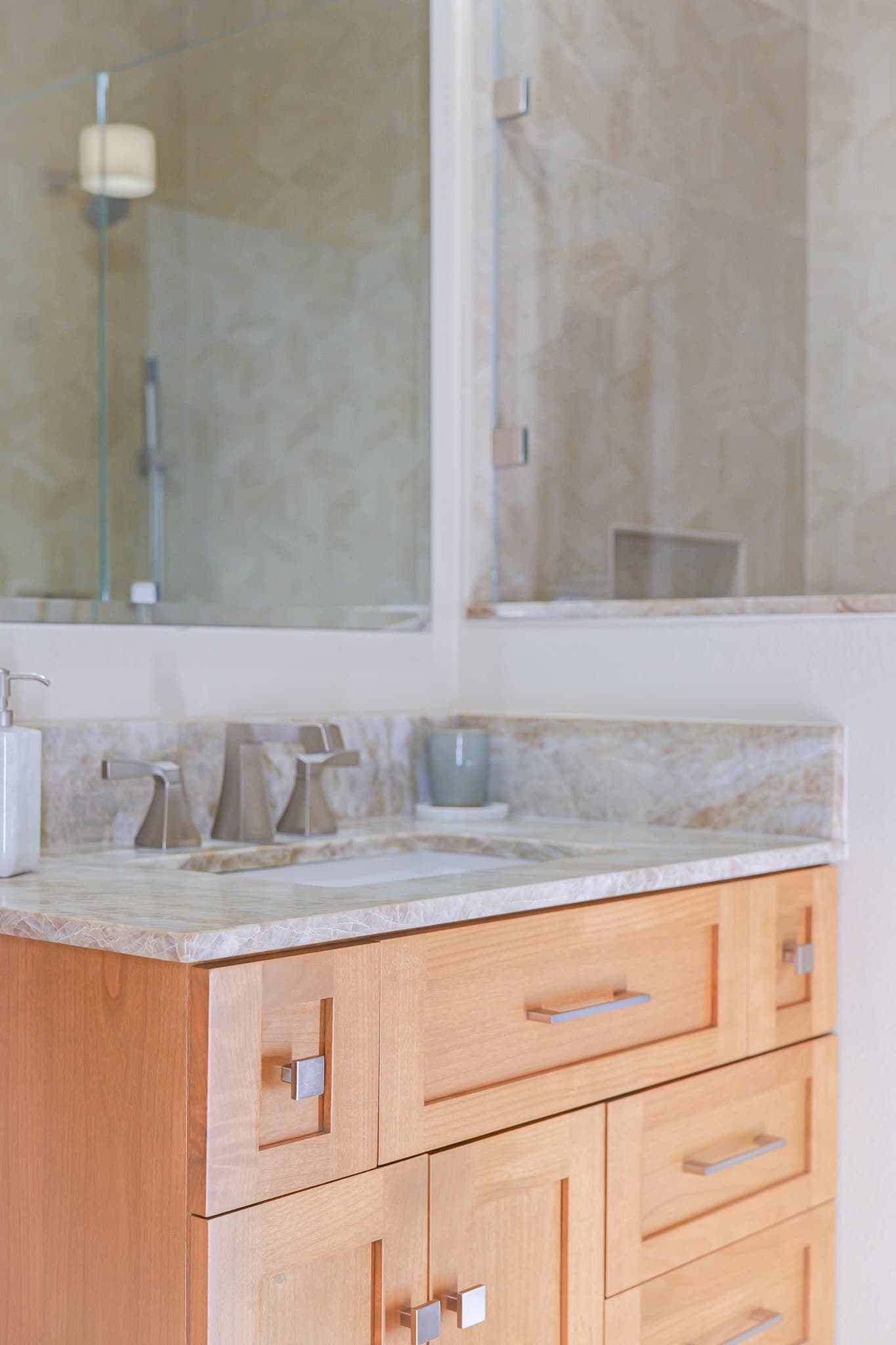 Bathroom Remodel in Sacramento — single vanity, undermount sink, frameless glass shower, tiled shower surround, natural-stone backsplash