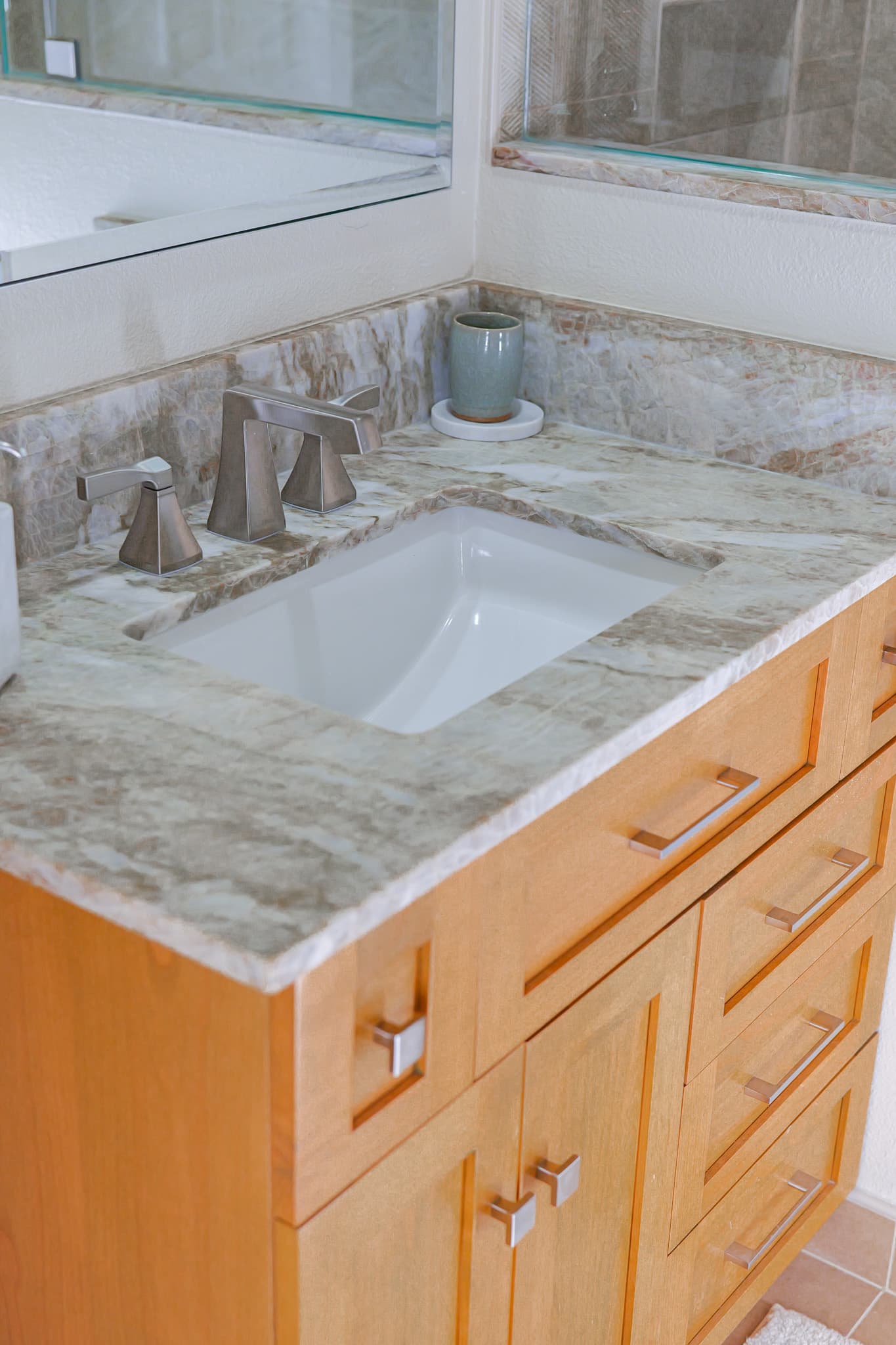 Bathroom Remodel in Sacramento — single vanity, undermount sink, marble countertop, natural-stone backsplash, frameless glass shower