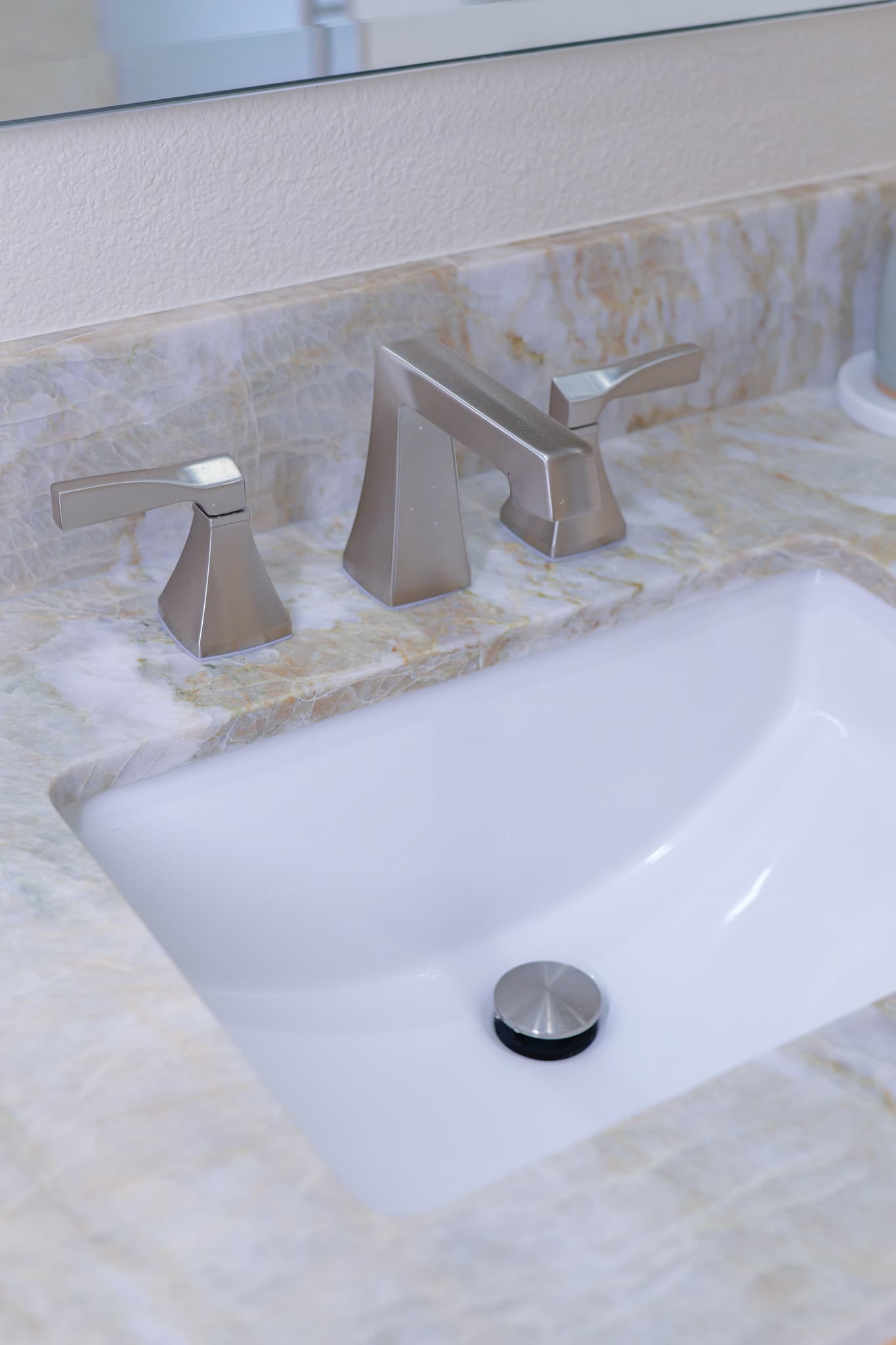 Bathroom Remodel in Sacramento — undermount sink, marble countertop, natural-stone backsplash, marble tile flooring, framed mirror