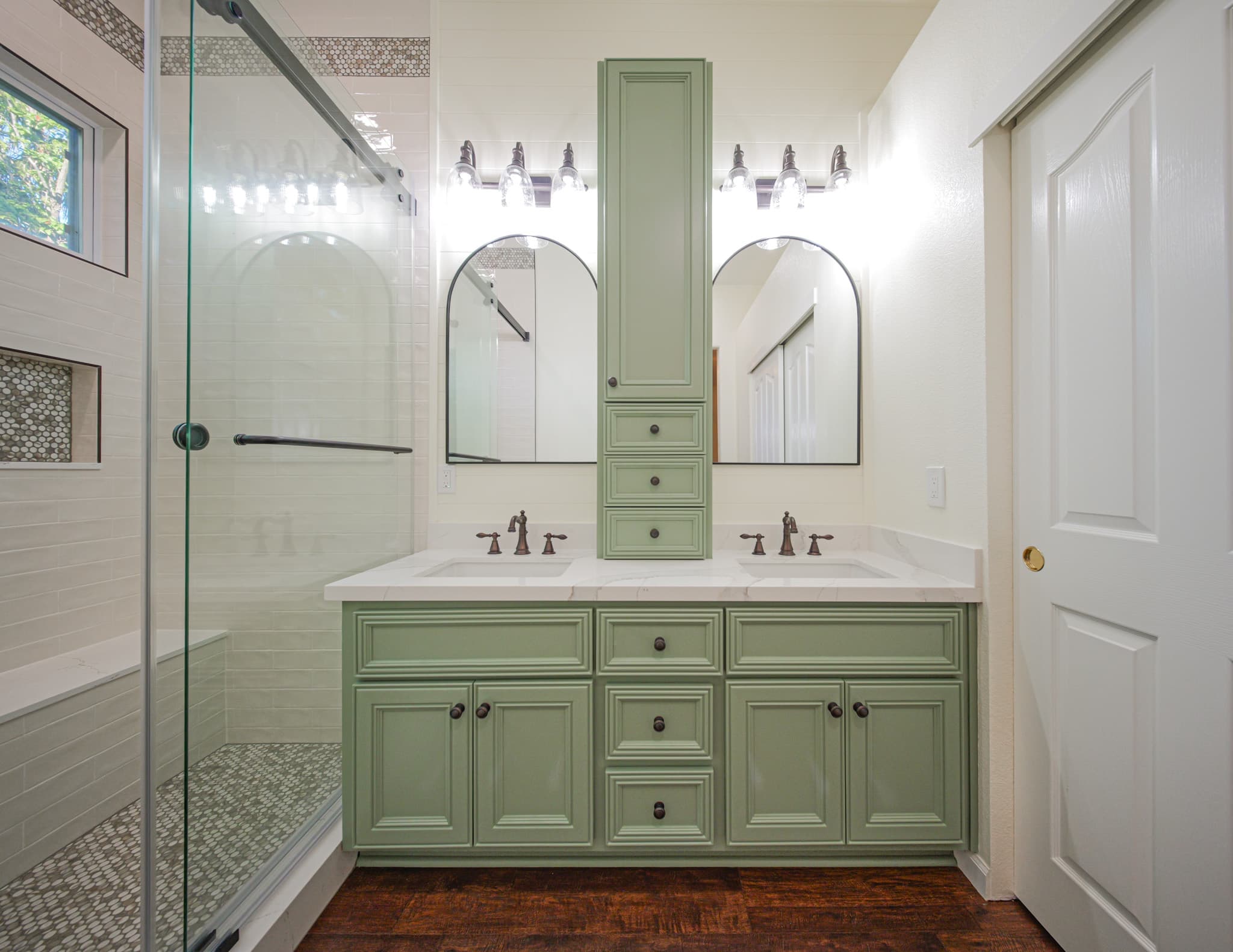 Bathroom Remodel in Sacramento — double vanity, raised-panel cabinets, frameless glass shower, tiled shower surround, linen tower