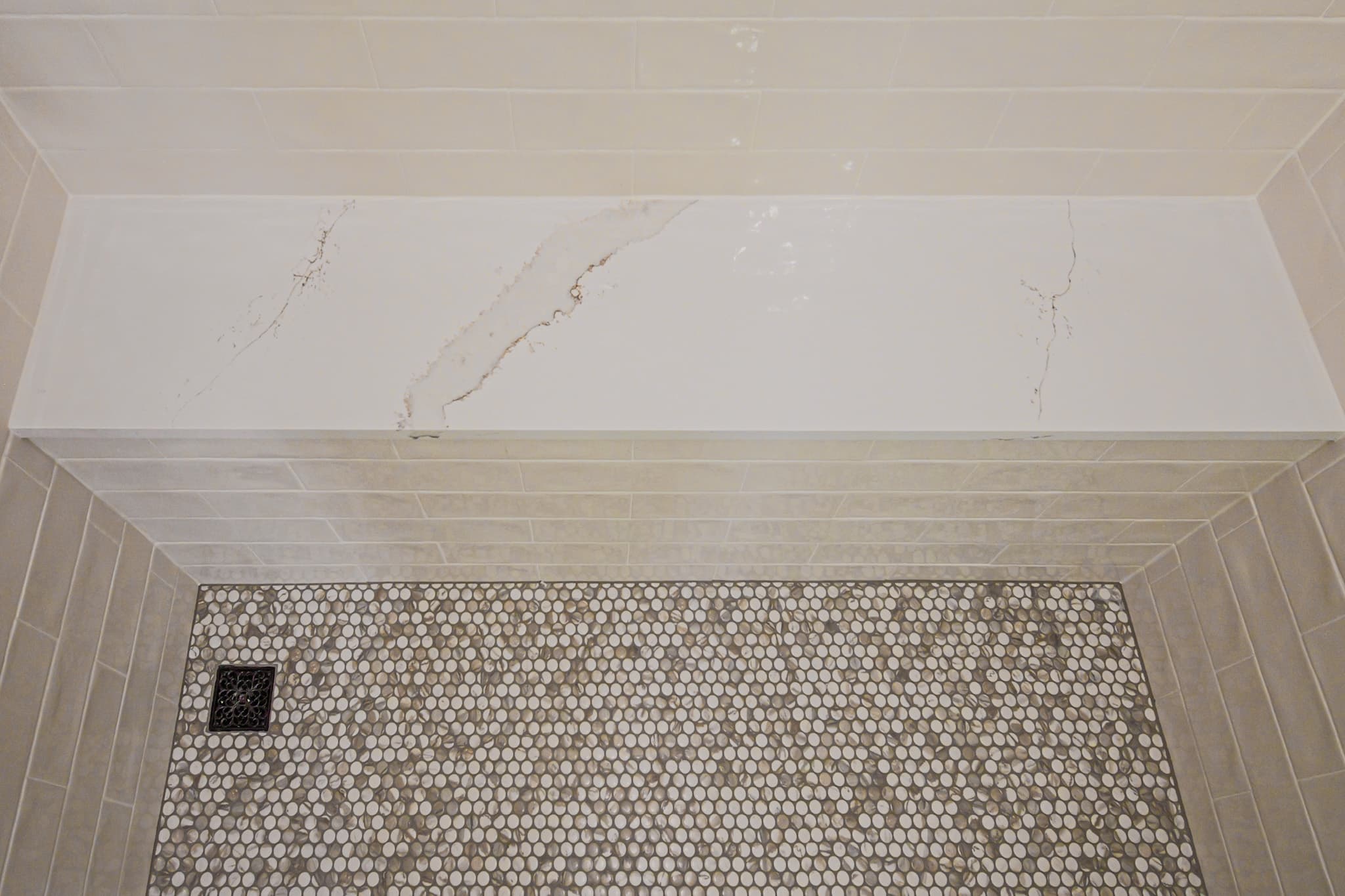 Bathroom Remodel in Sacramento — walk-in shower, shower bench, mosaic backsplash, tiled shower surround, quartz countertop