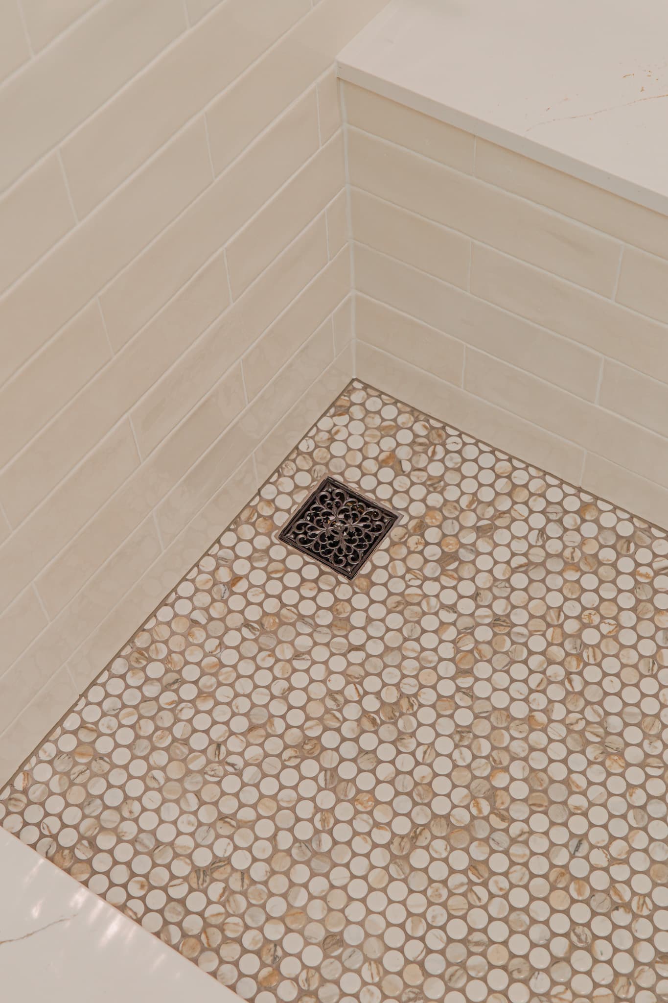 Bathroom Remodel in Sacramento — walk-in shower, tiled shower surround, mosaic backsplash, shower bench, natural-stone tile flooring