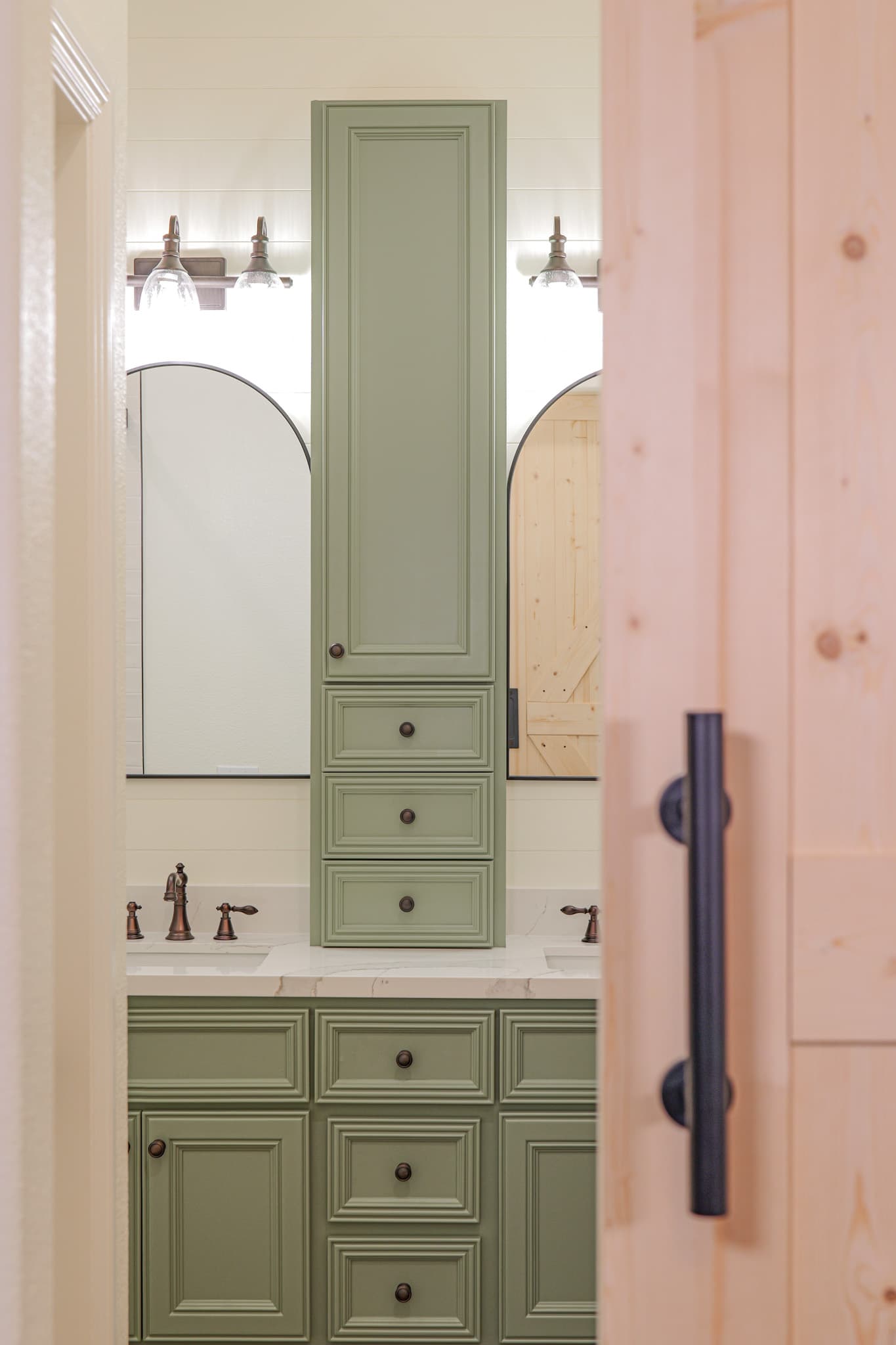 Bathroom Remodel in Sacramento — raised-panel cabinets, double vanity, linen tower, barn-door entry, marble countertop