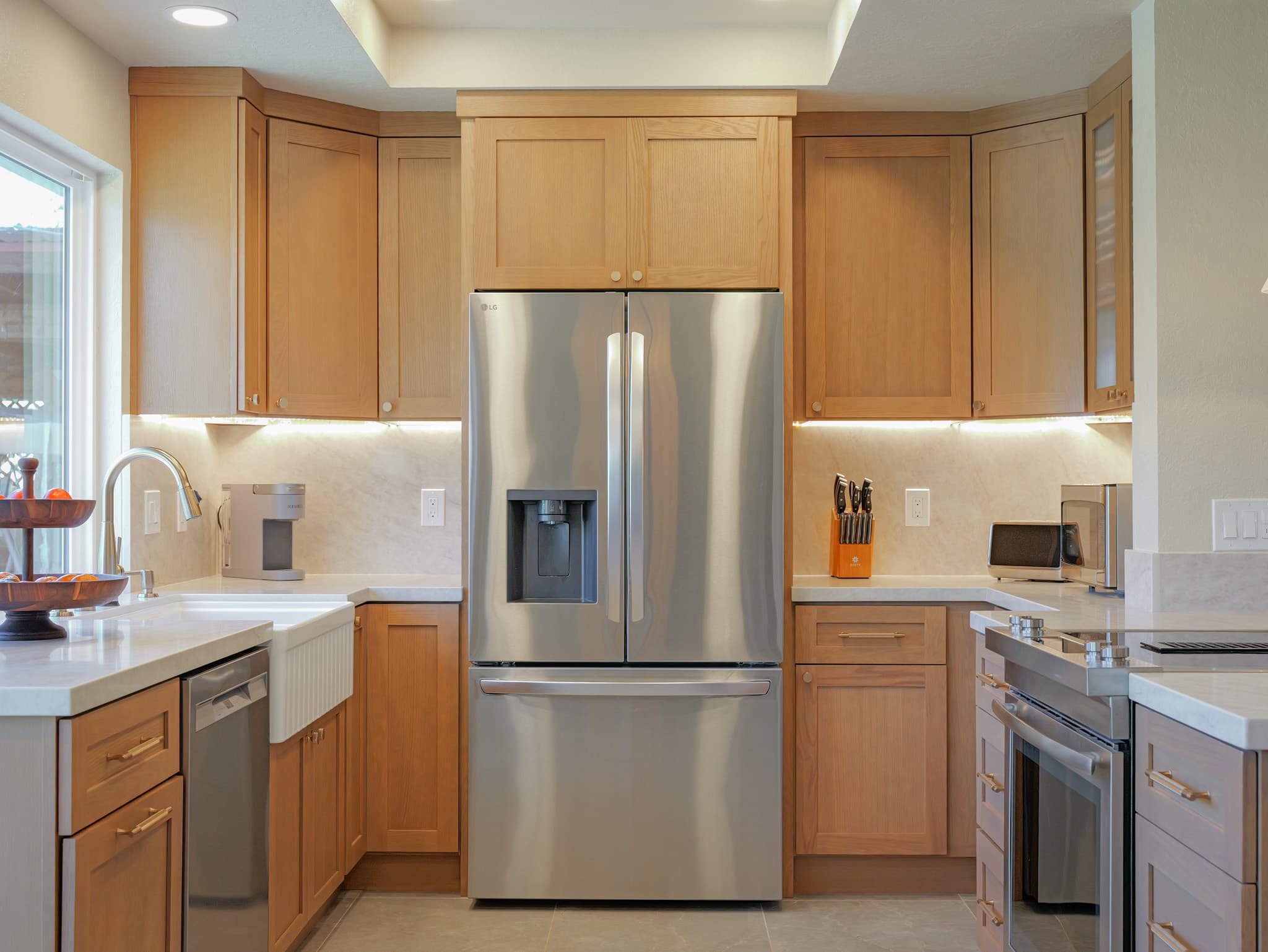 House Renovation in Sacramento — shaker cabinets, under-cabinet lighting, quartz countertop, farmhouse sink, stainless appliances