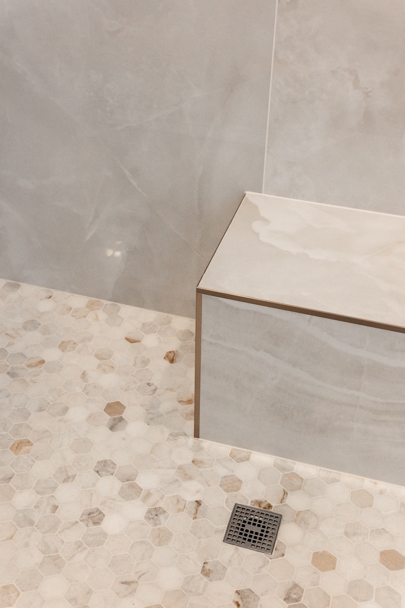 Bathroom Remodel in Sacramento — walk-in shower, shower bench, tiled shower surround, mosaic backsplash, natural-stone tile flooring