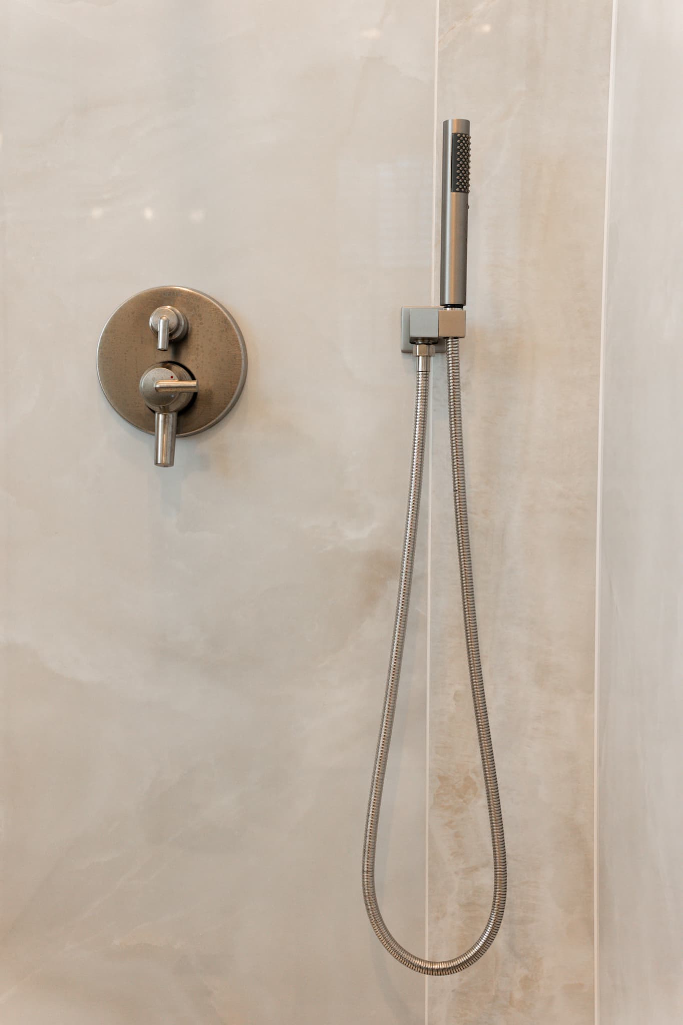 Bathroom Remodel in Sacramento — handheld shower, tiled shower surround, walk-in shower, natural-stone tile flooring