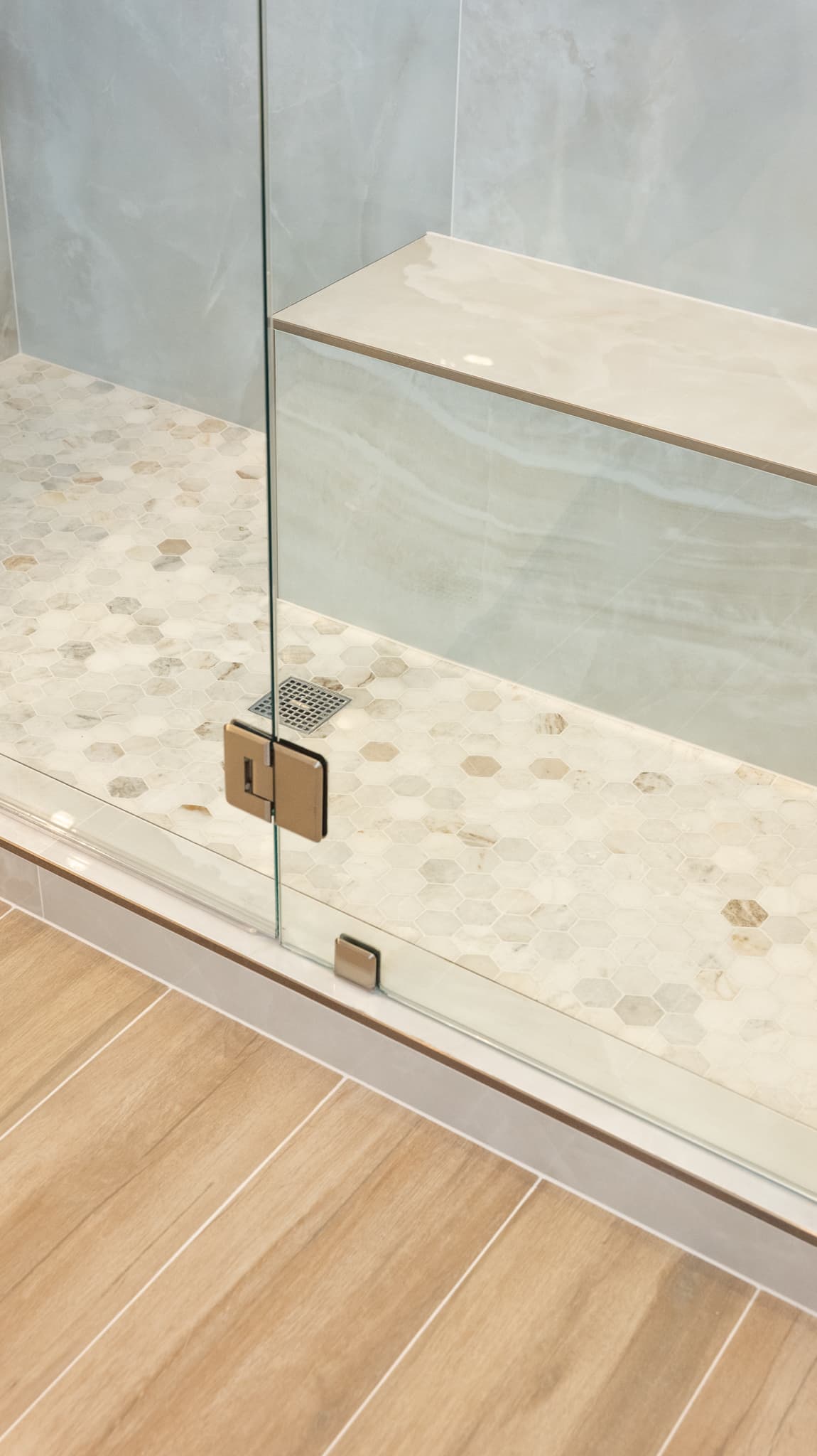Bathroom Remodel in Sacramento — frameless glass shower, walk-in shower, shower bench, mosaic backsplash, porcelain tile flooring