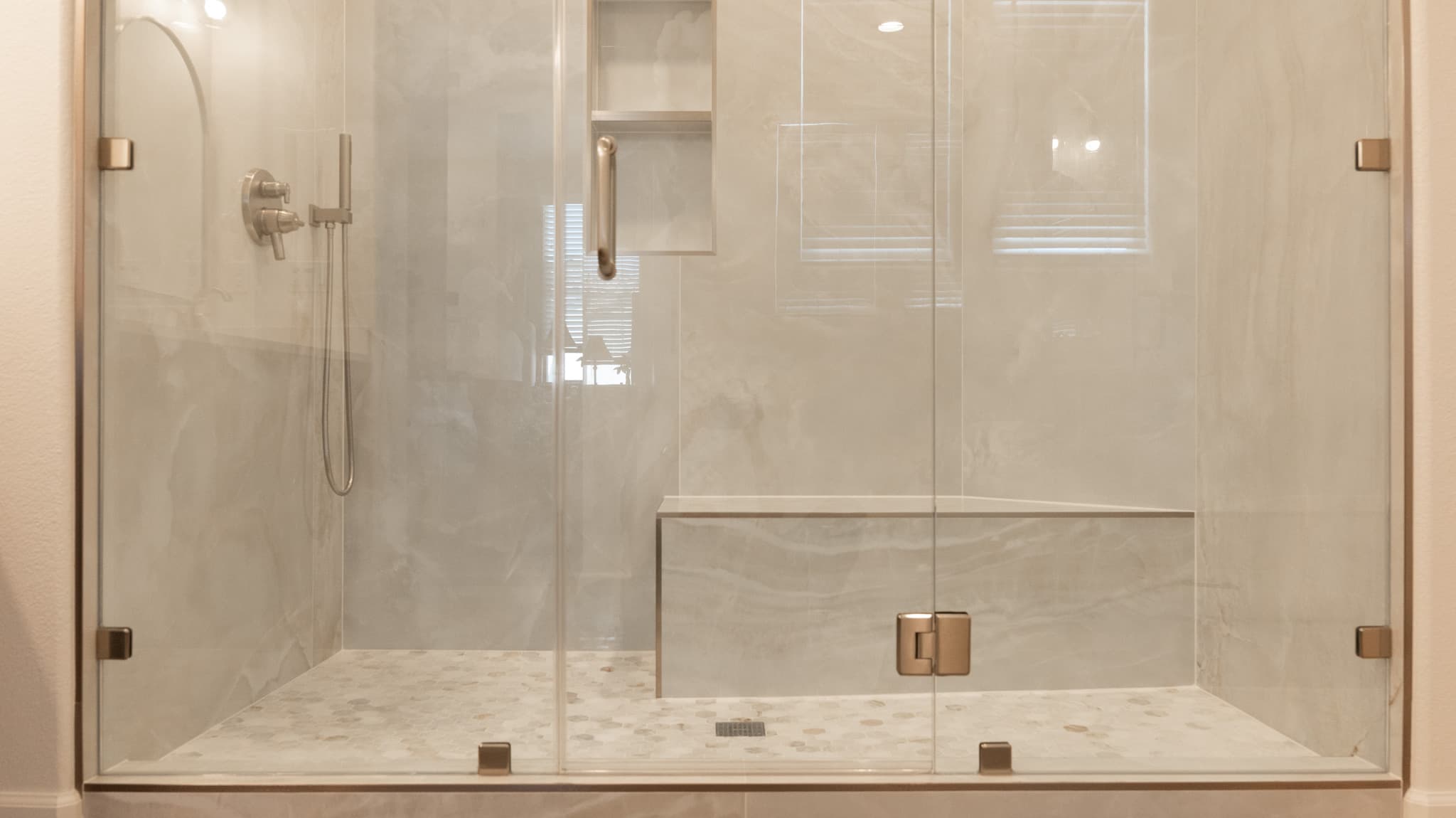 Bathroom Remodel in Sacramento — frameless glass shower, walk-in shower, tiled shower surround, shower bench, handheld shower