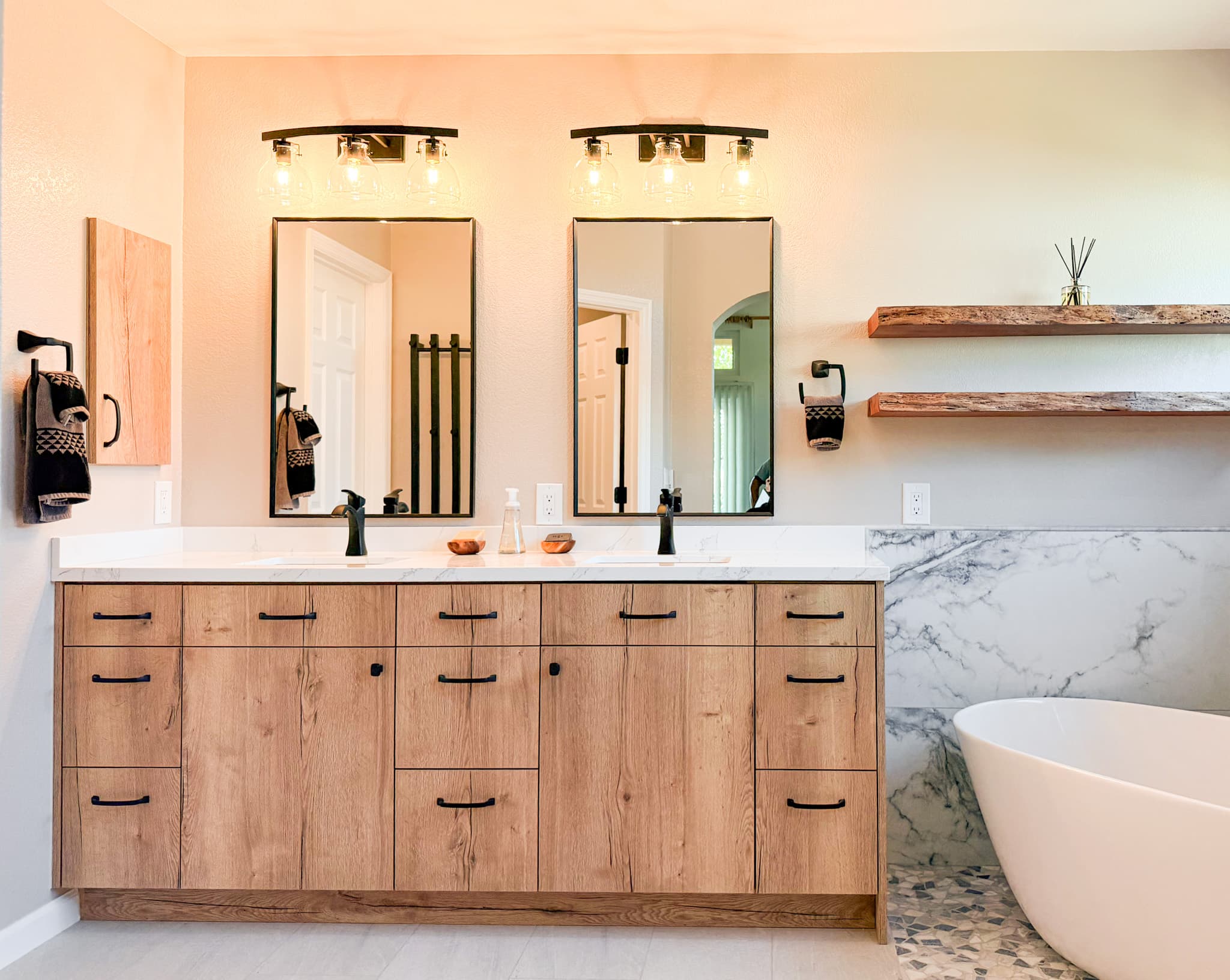 Bathroom Remodel in El Dorado Hills — double vanity, framed mirror, freestanding tub, quartz countertop, built-in shelving