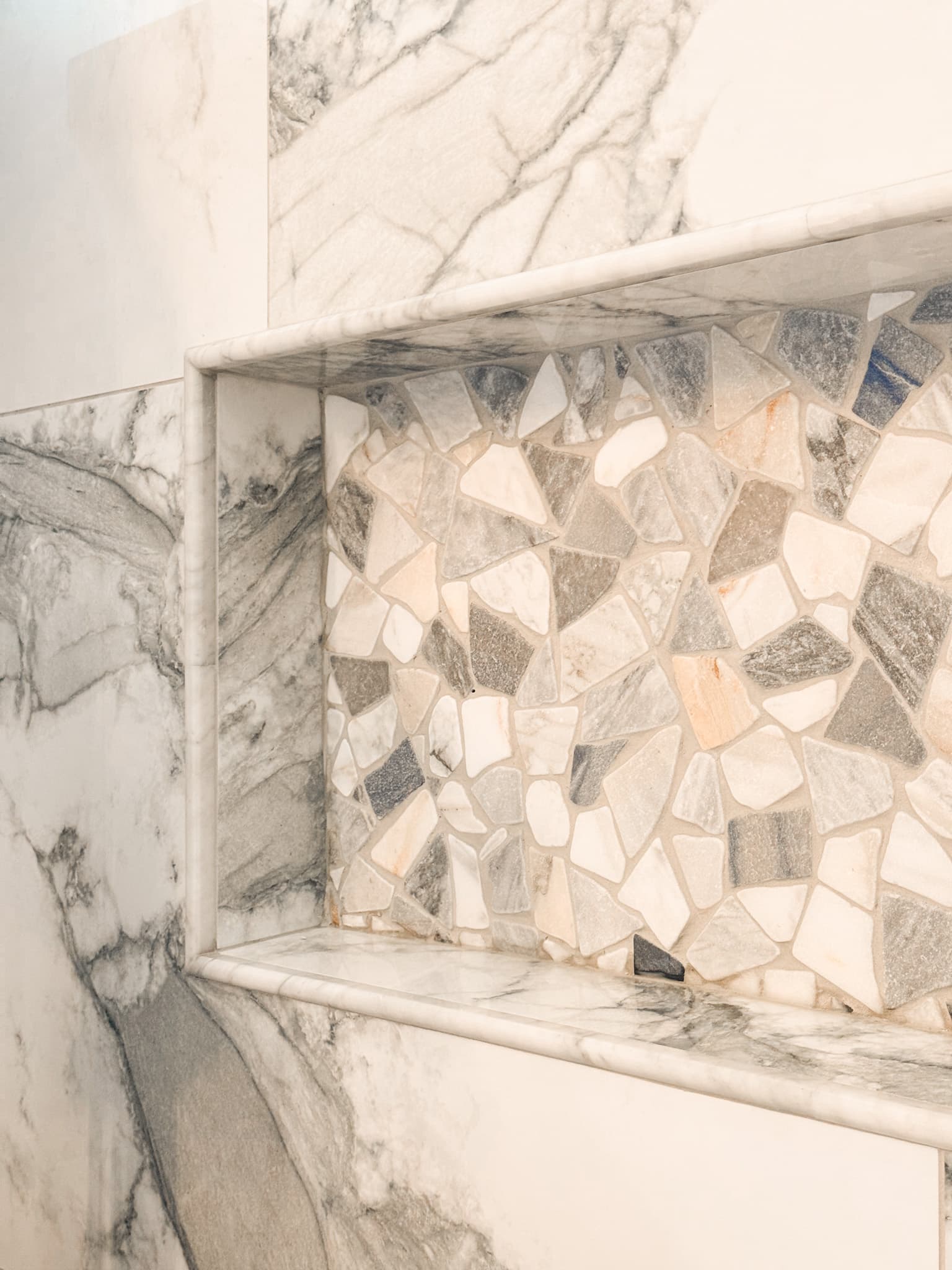 Bathroom Remodel in El Dorado Hills — tiled shower surround, natural-stone backsplash, mosaic backsplash, marble tile flooring, walk-in shower