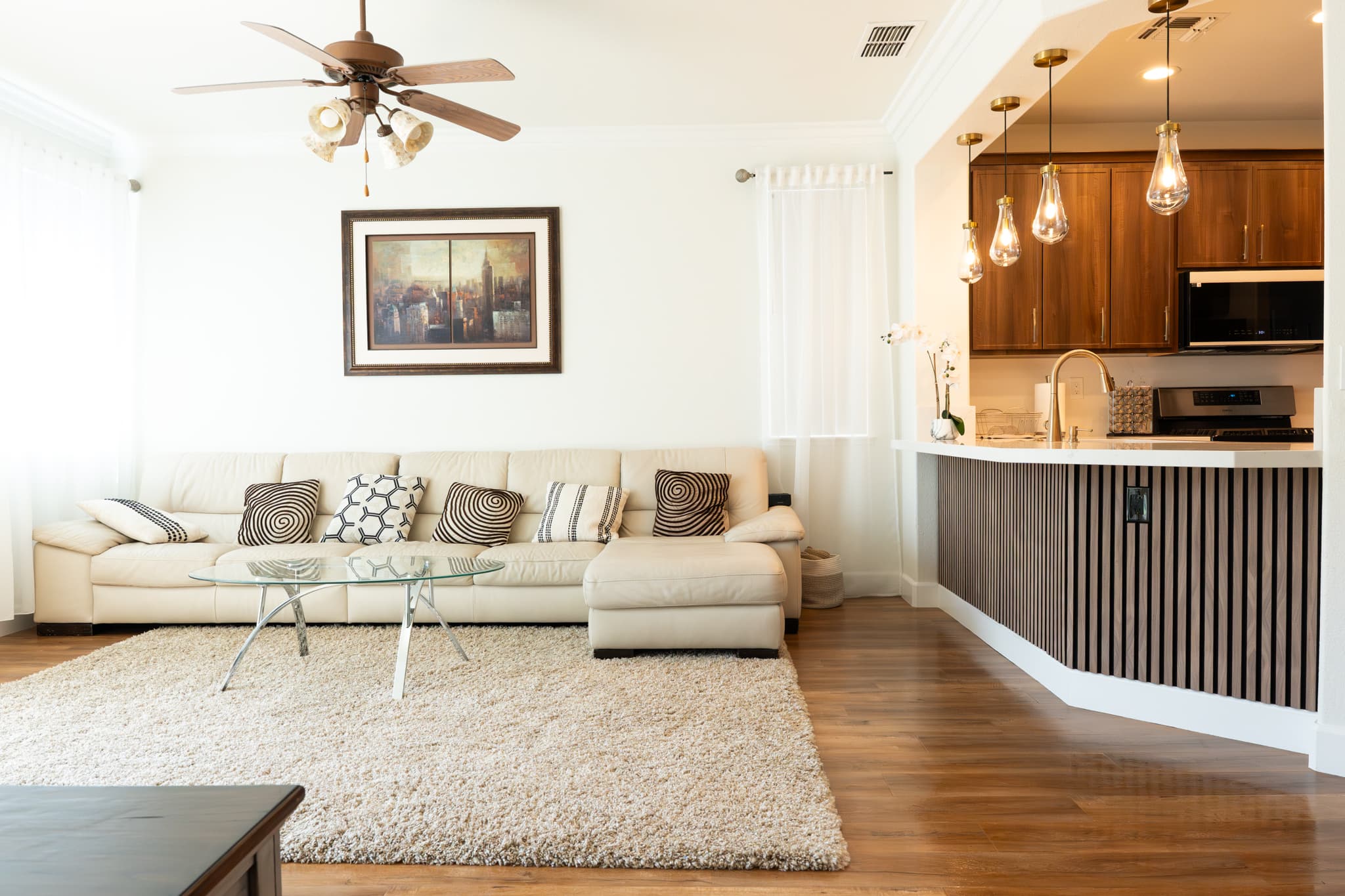 House Renovation in Roseville — open-concept layout, pendant lighting, hardwood flooring, breakfast bar, stainless appliances