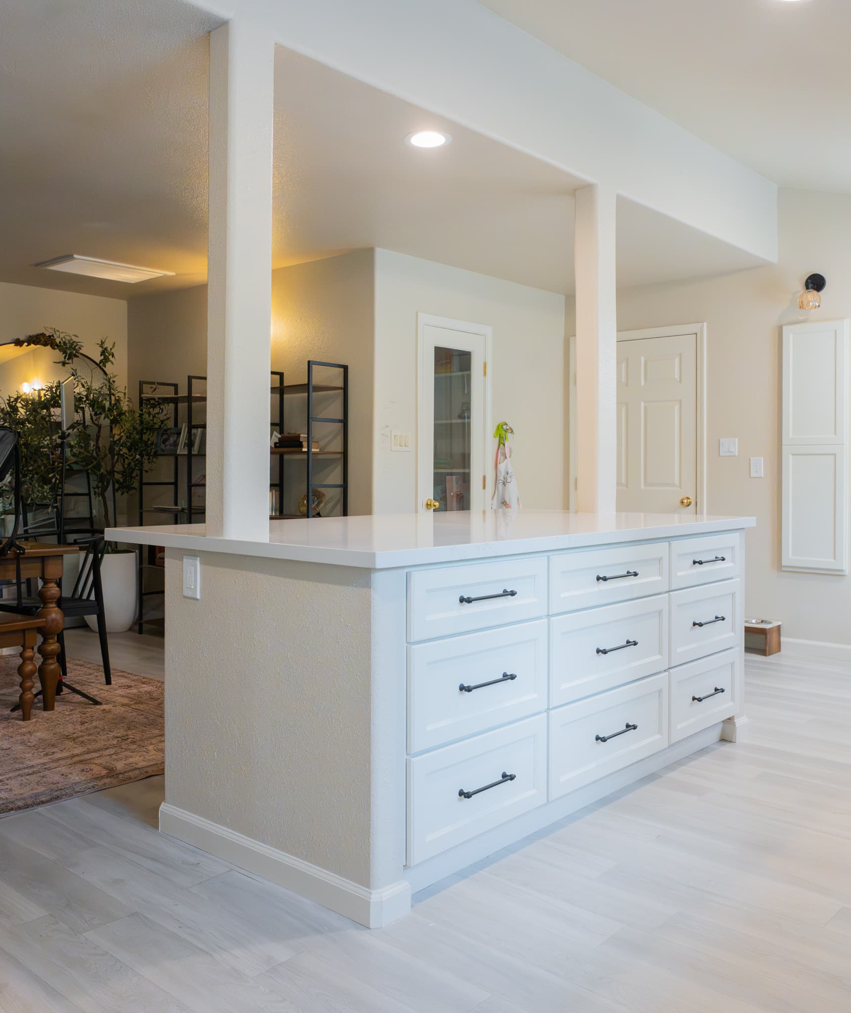 Kitchen Remodel in Rocklin — kitchen island, shaker cabinets, quartz countertop, recessed lighting, luxury vinyl plank