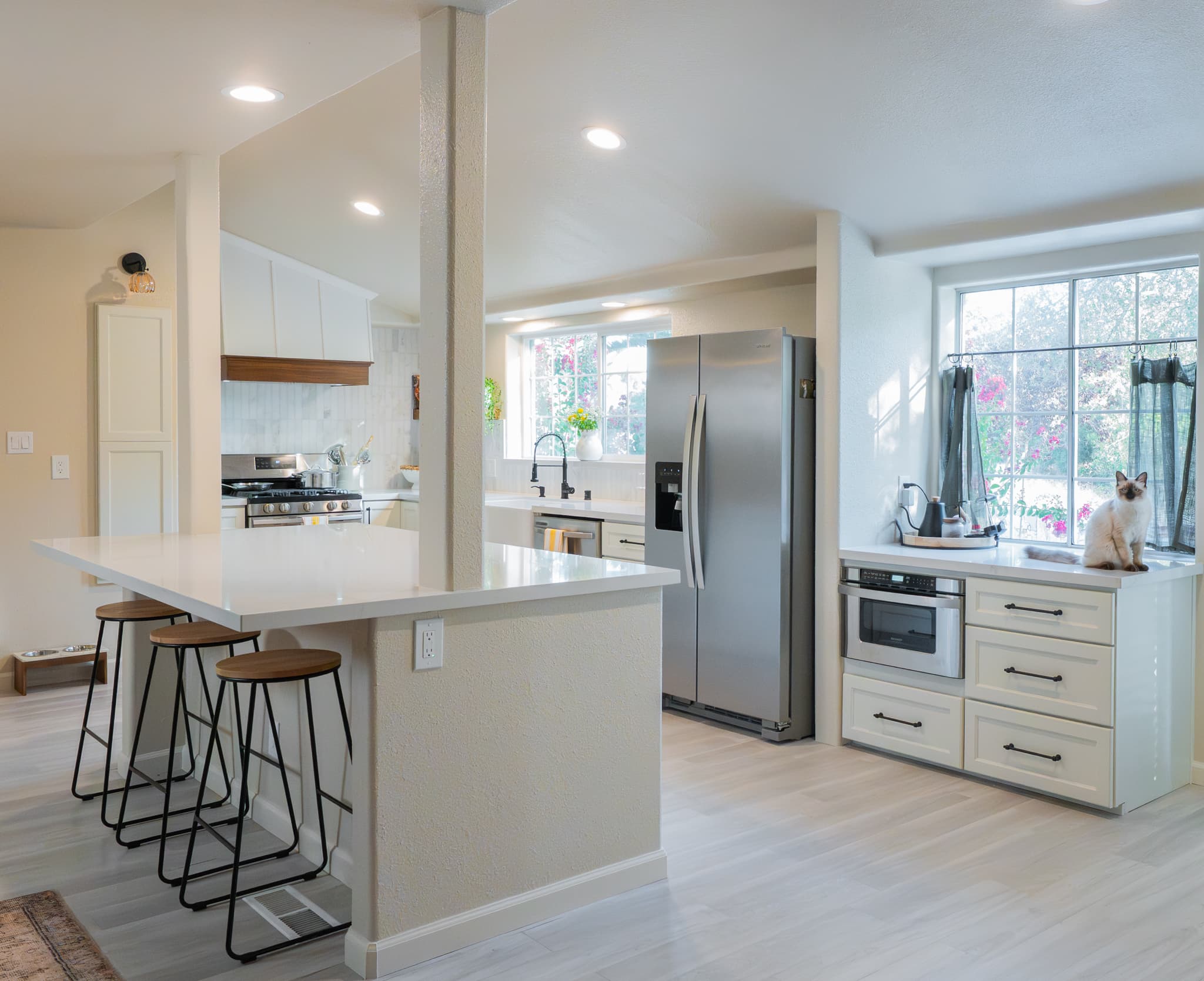 Kitchen Remodel in Rocklin — breakfast bar, quartz countertop, stainless appliances, recessed lighting, luxury vinyl plank