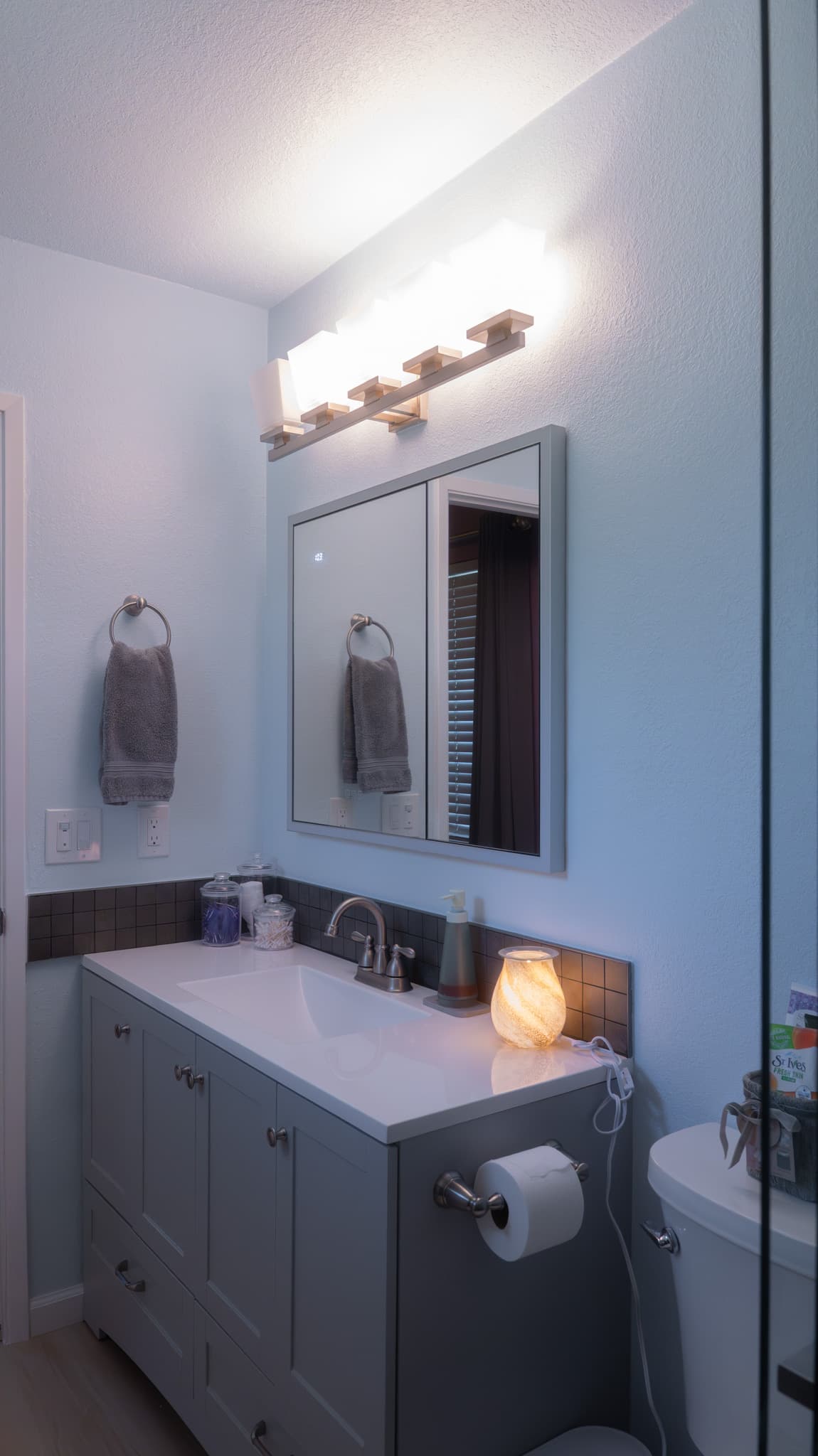 Kitchen Remodel in Sacramento — single vanity, shaker cabinets, framed mirror, quartz countertop, frameless glass shower